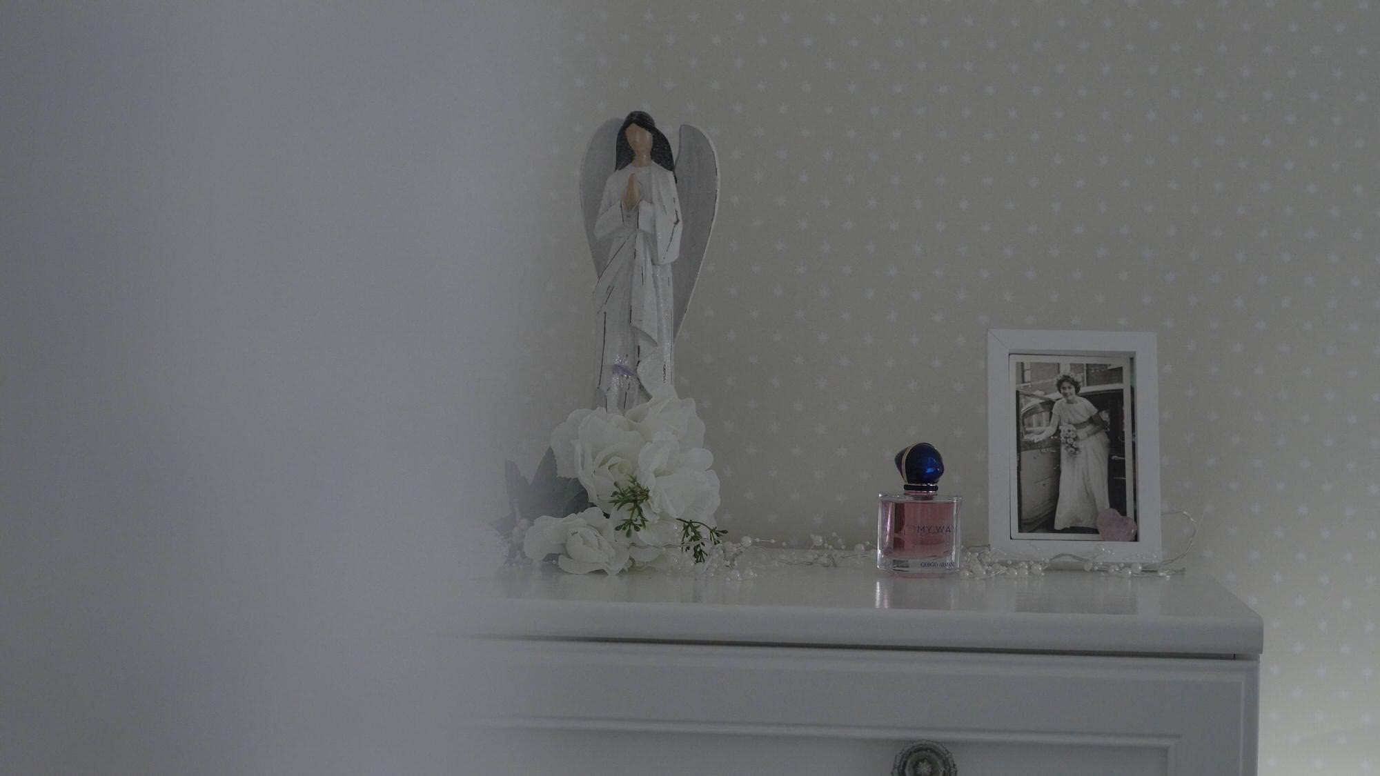 old wedding photo sits by new wedding dress