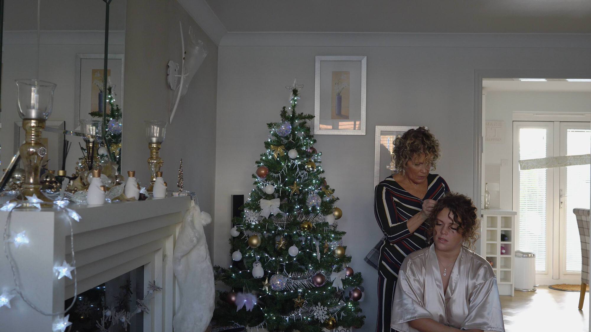 mother of the bride helps fix her hair before Preston ceremony