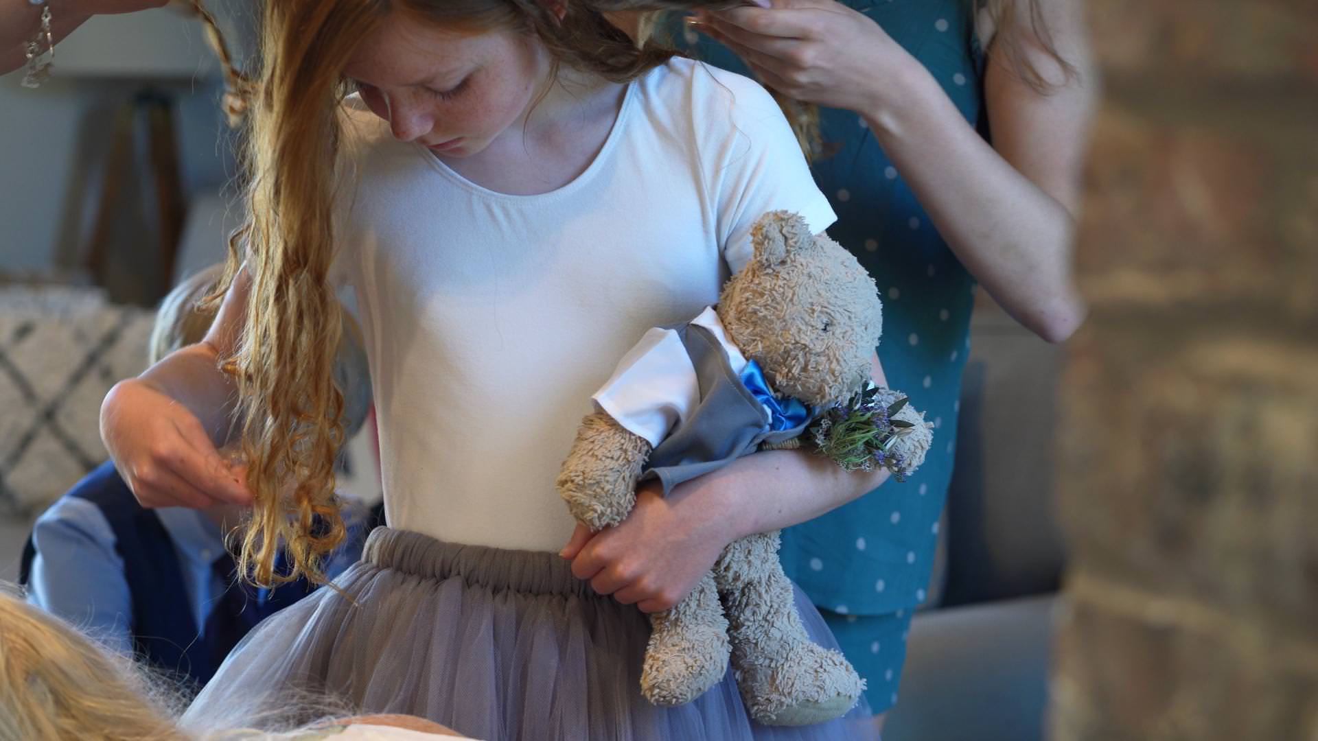 flower girl holds vintage winnie the pooh