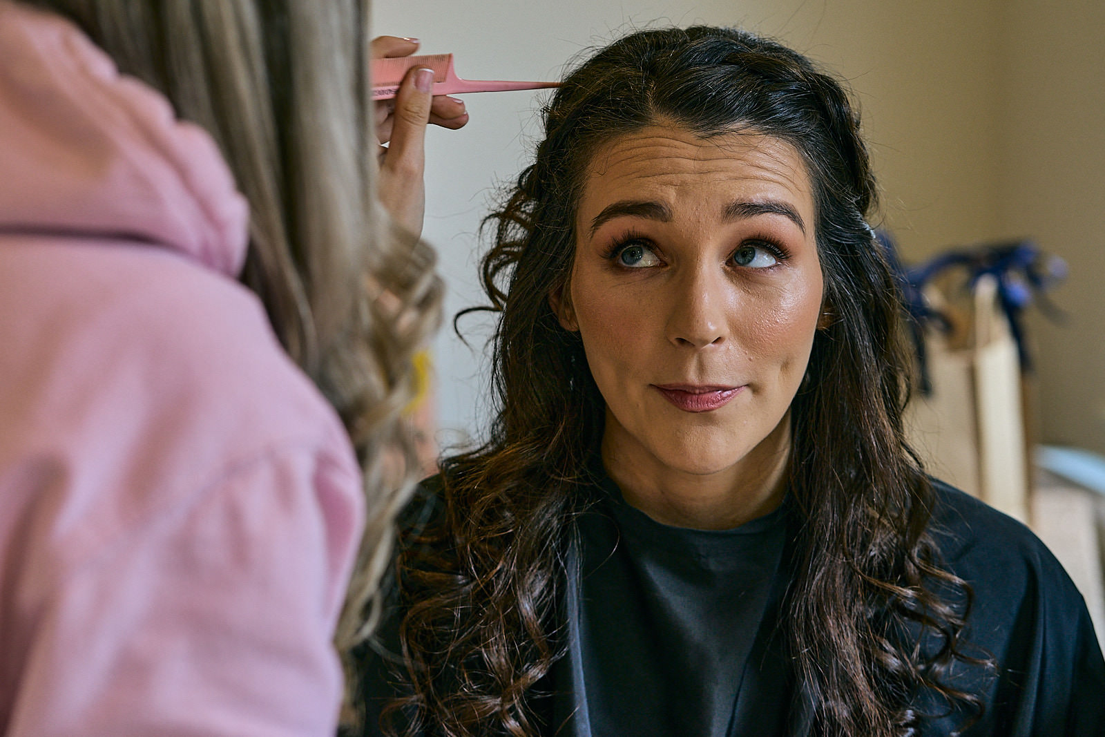 fun natural photograph of bride getting hair done in Crosby