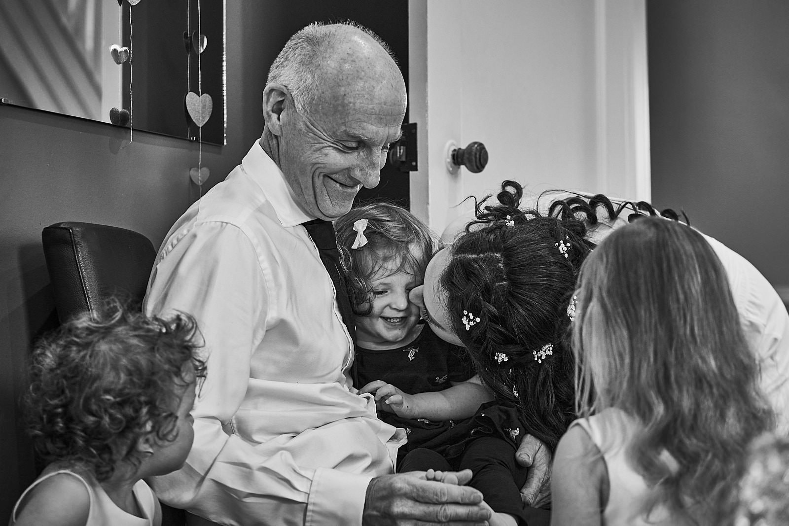 natural documentary photo of dad with flowergirl and bride