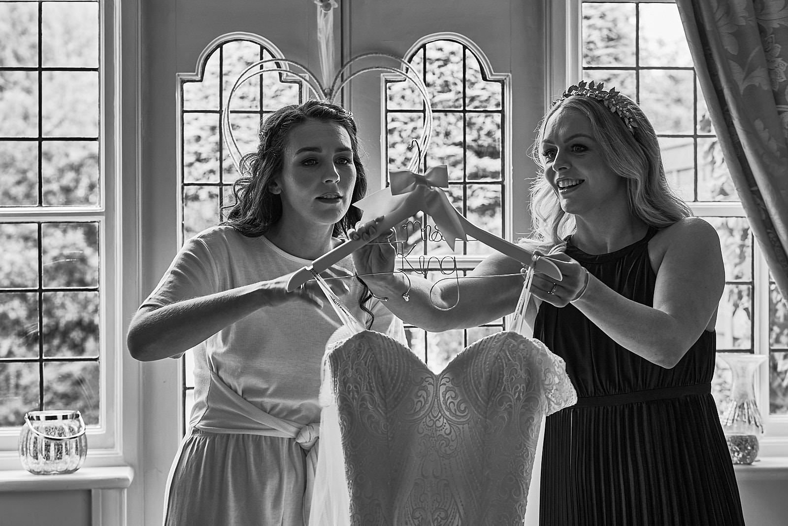natural photo of bride with sister getting ready