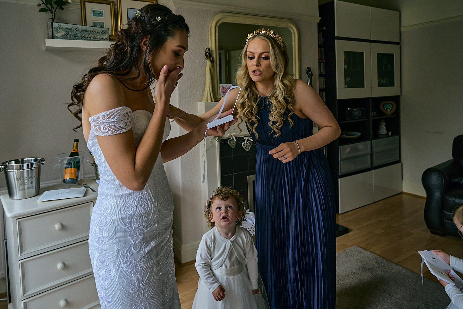 bride holds back tears getting wedding gift