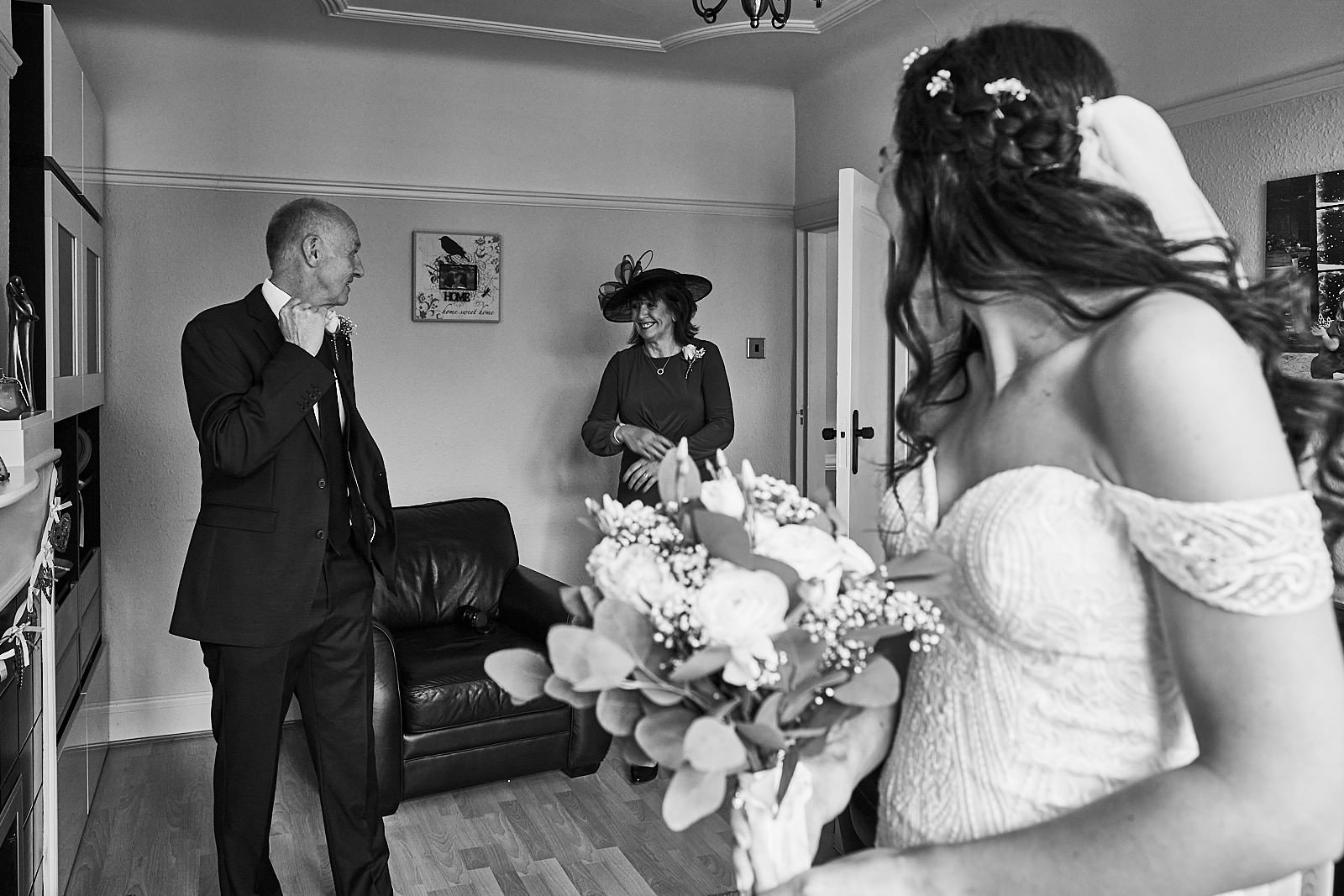 mum and dad see daughter in her wedding dress