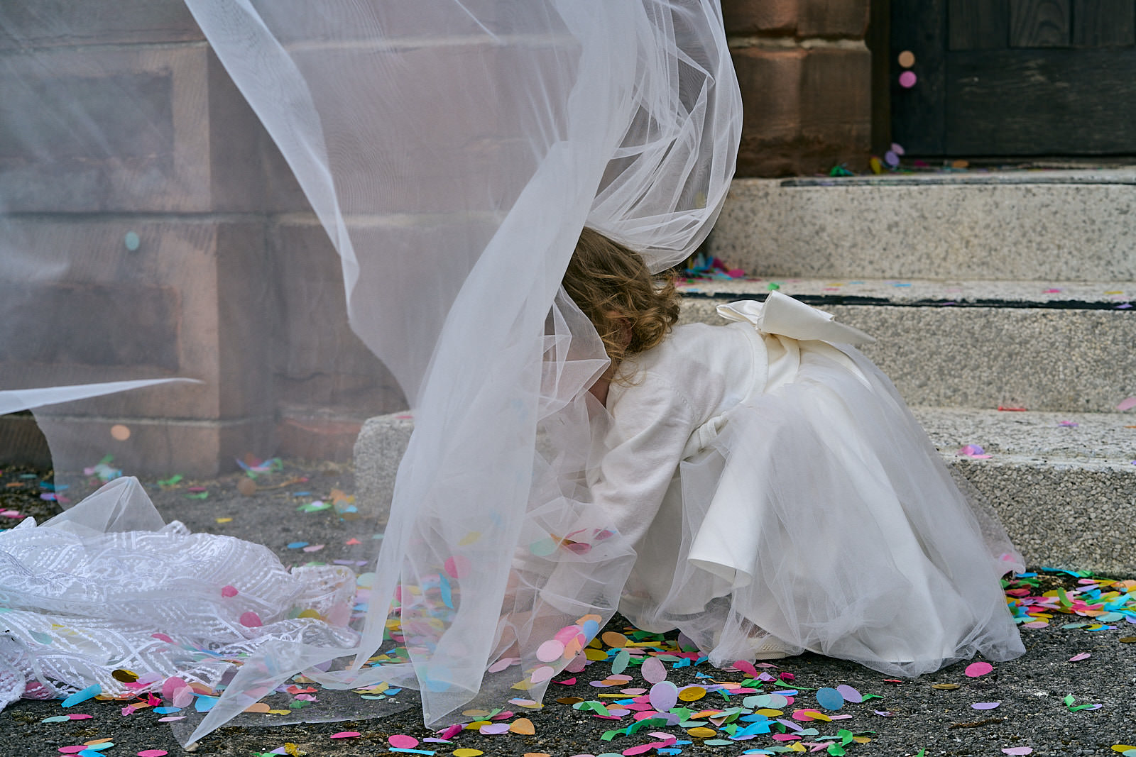 flower girl collects confetti and caught in veil