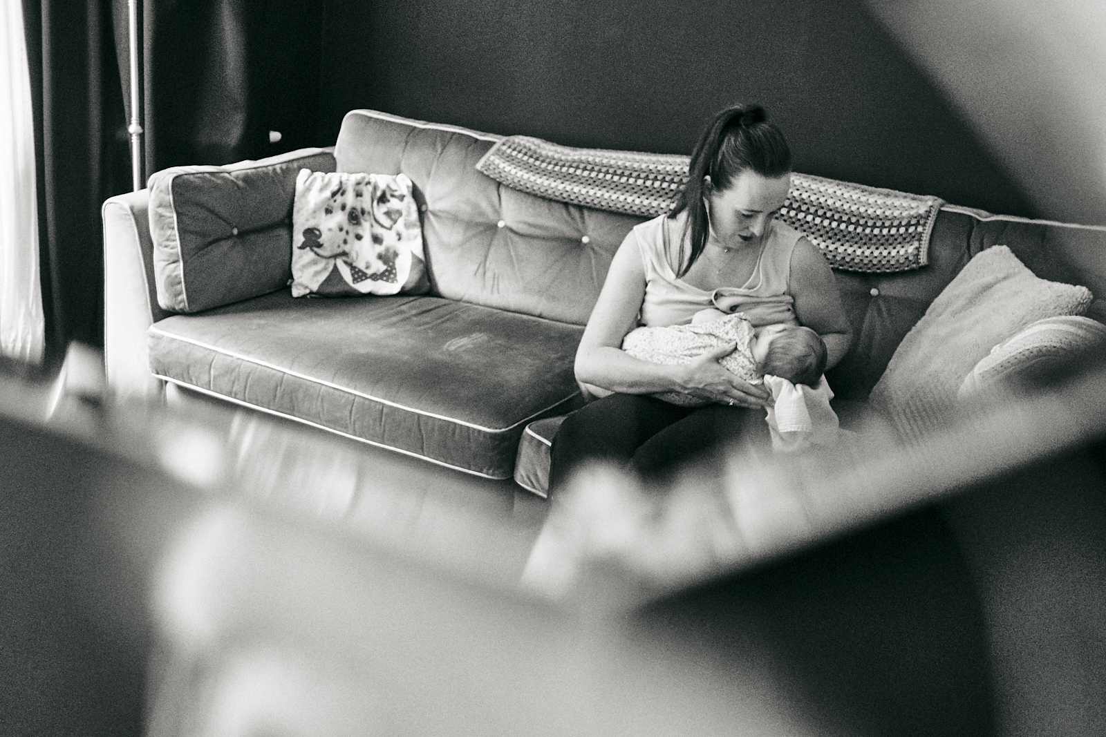 photo through mirror of mum feeding daughter