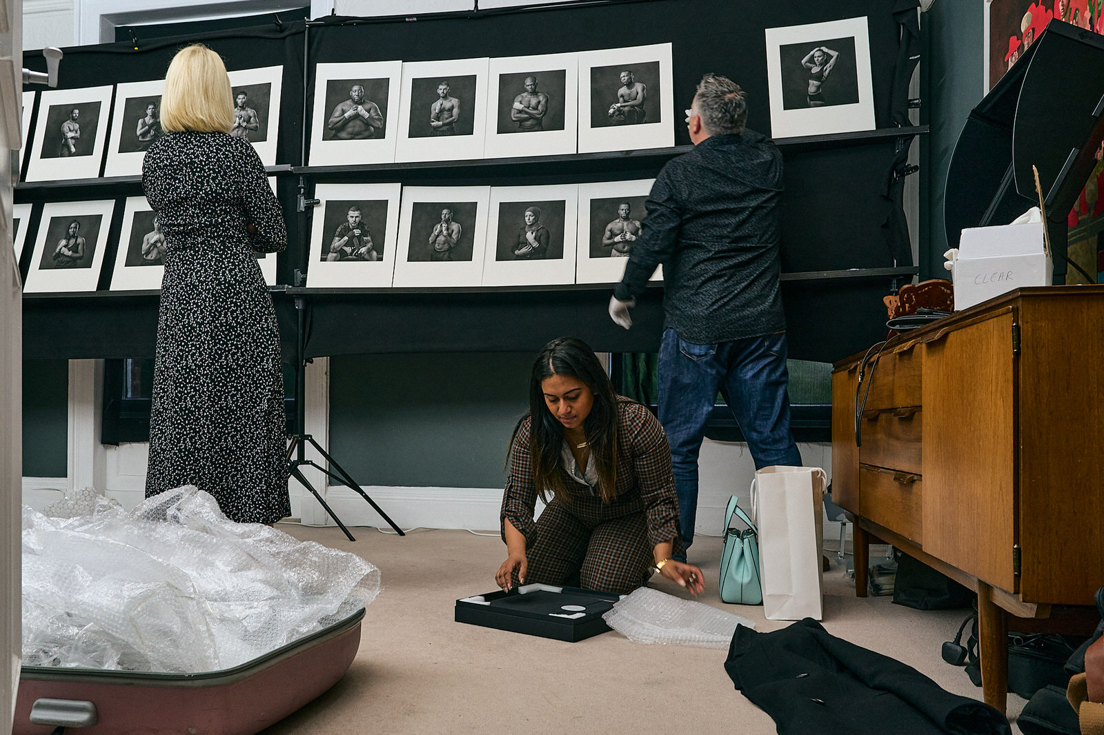 documentary photographer unpacks her photography prints to display