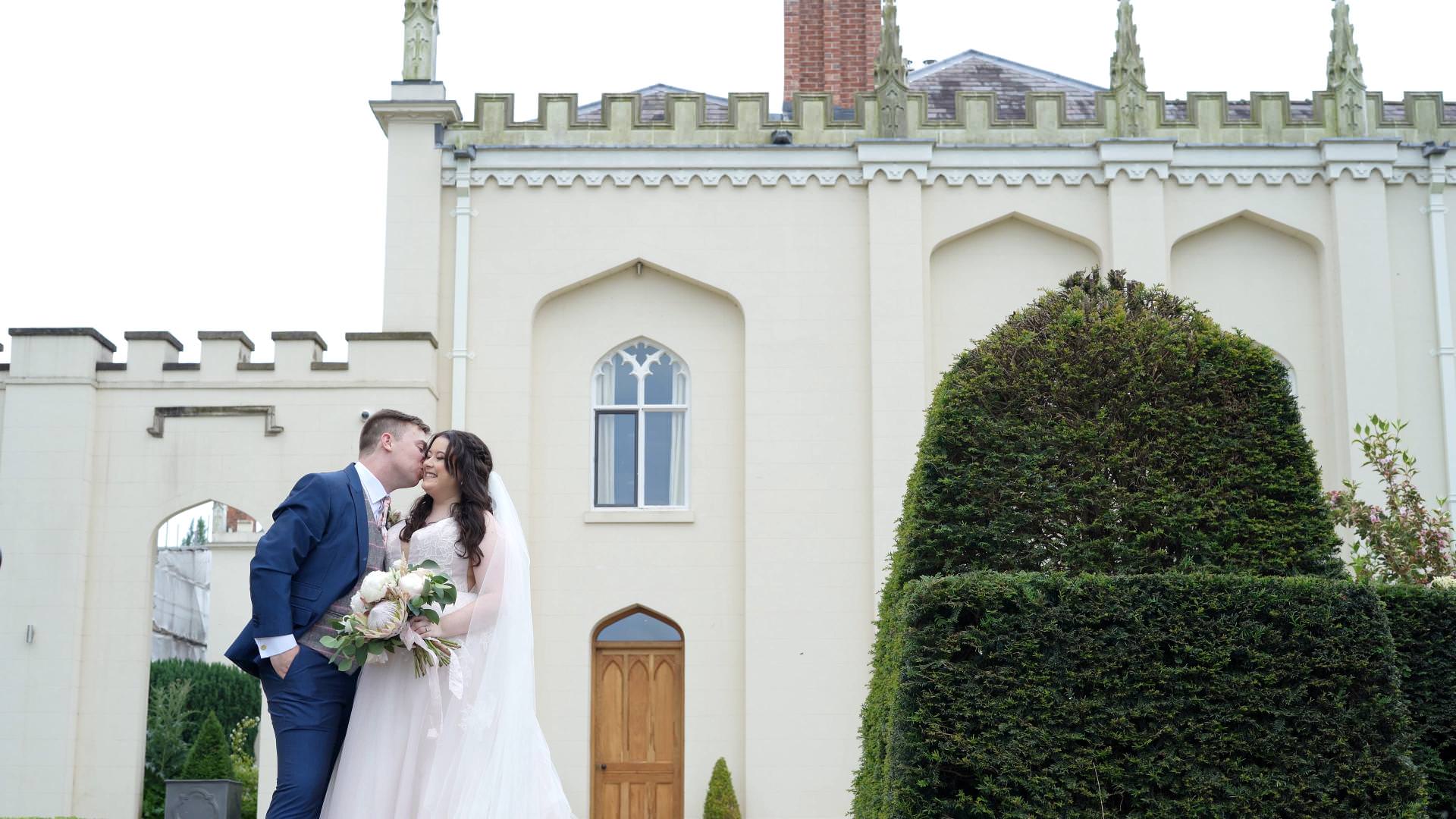 couple pose outside Combermere Abbey