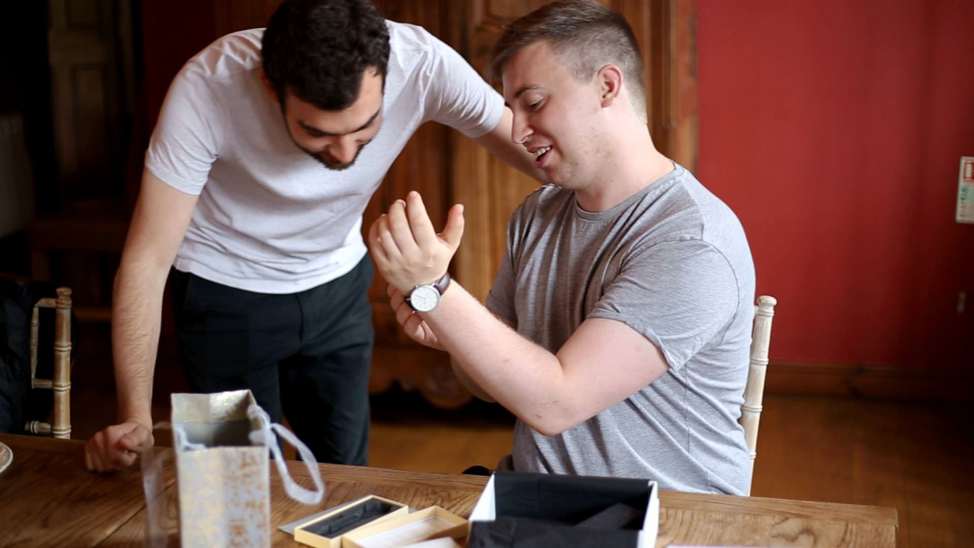 groom opening gifts on wedding morning