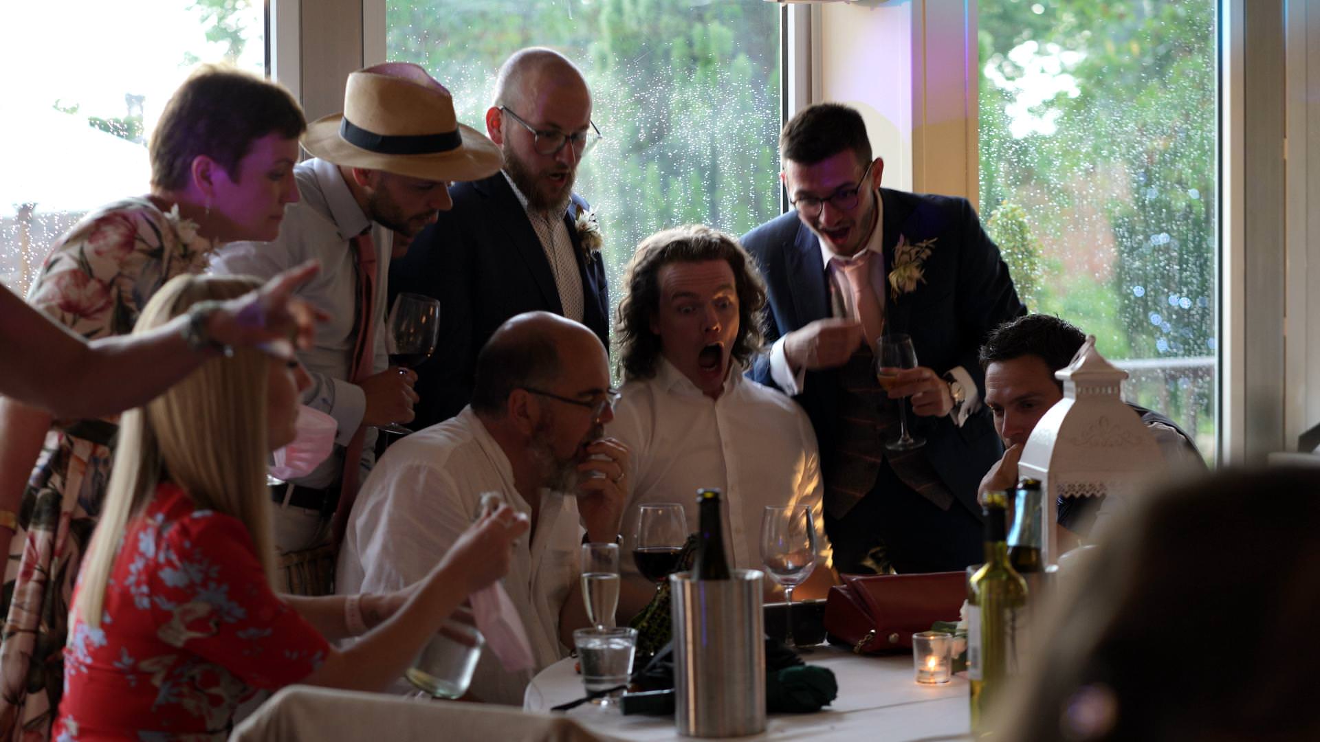 guests react to football during wedding