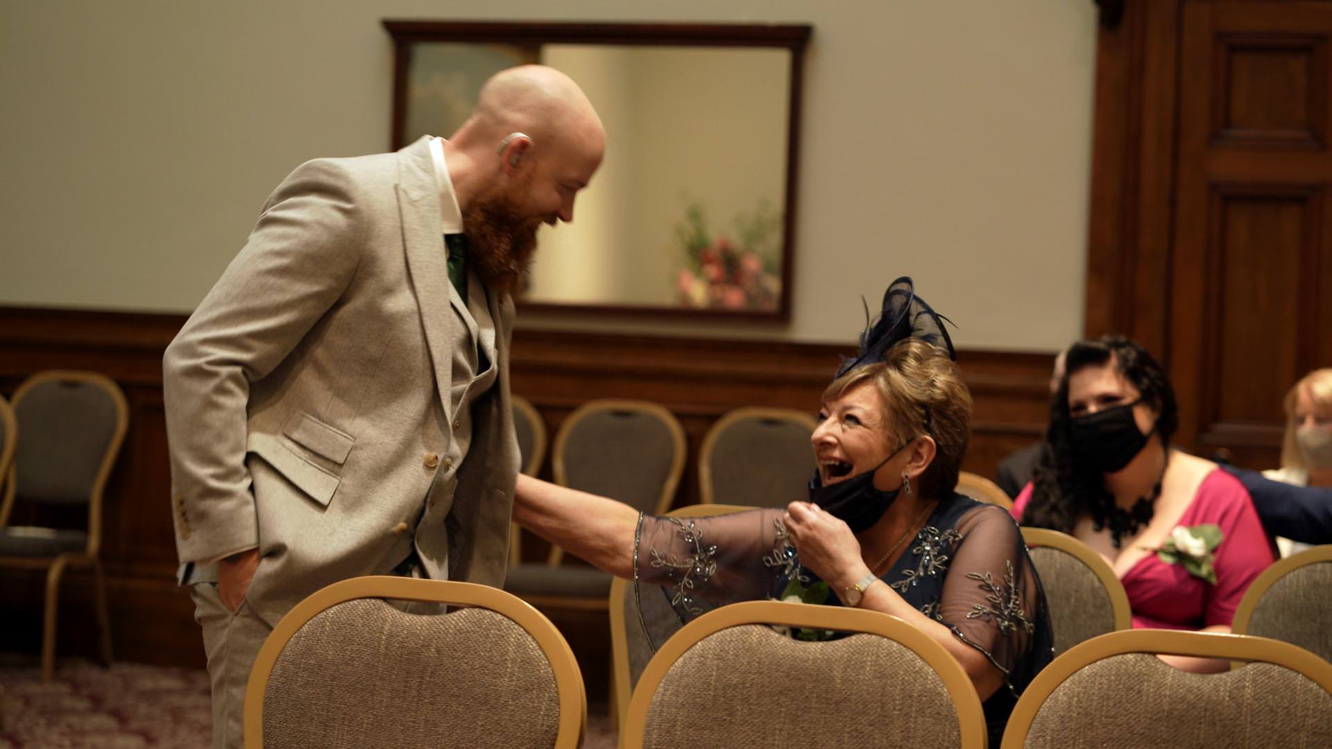 guests laugh with groom in Grand Jury Room Liverpool