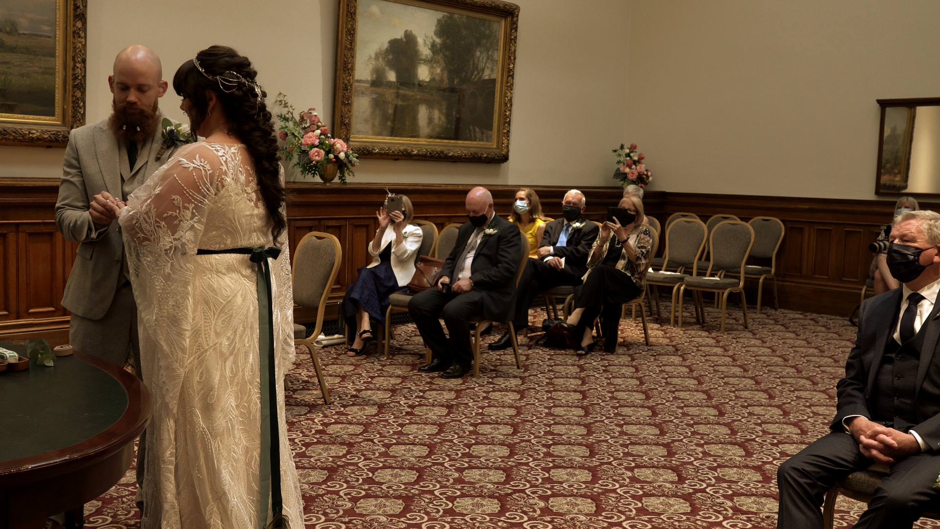 exchanging wedding rings during St Georges Hall ceremony