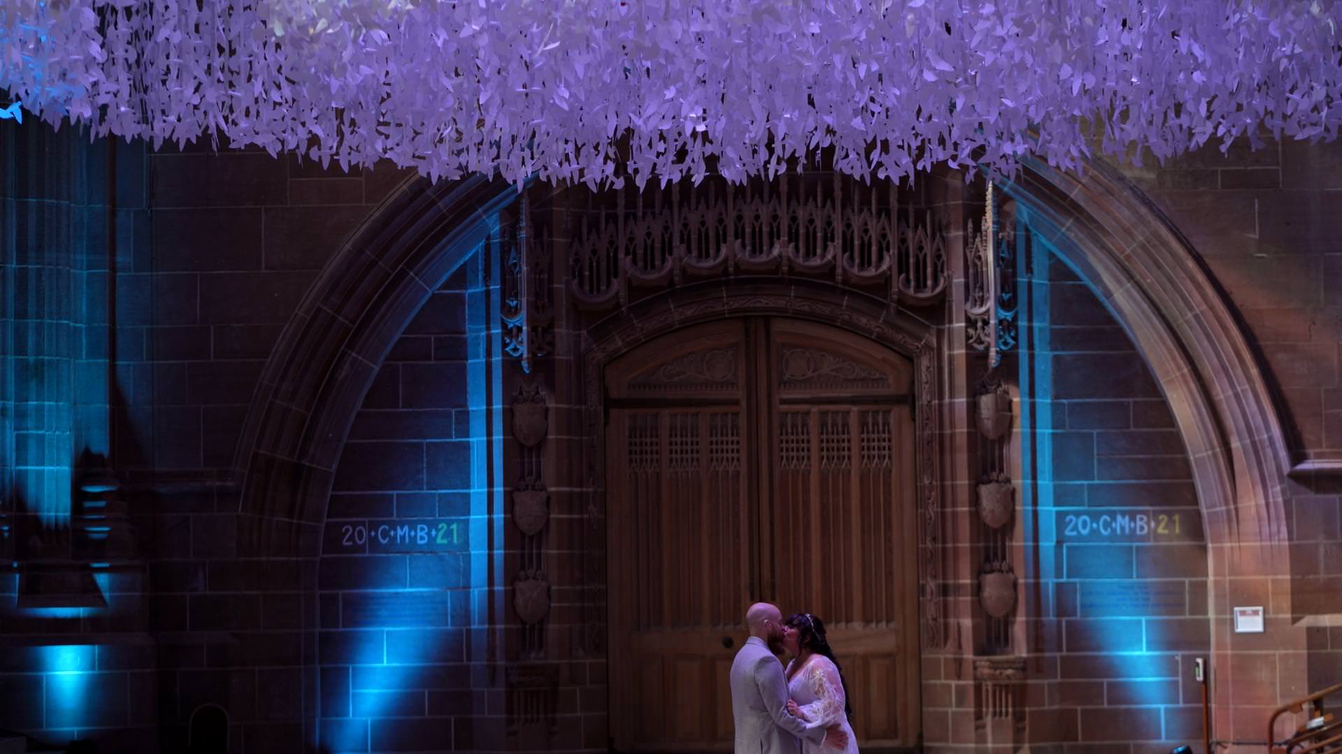 vide still of bride and groom under peace doves Liverpool