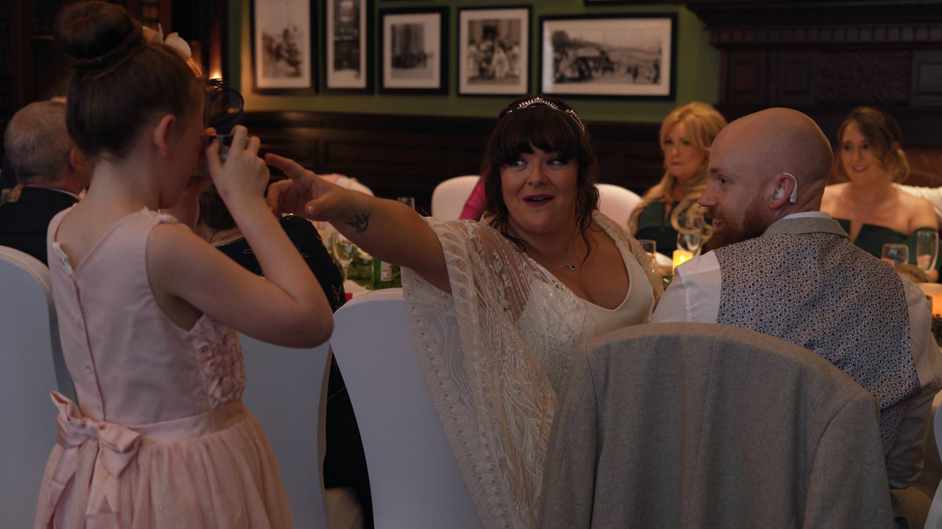 flower girls take photos of guests at liverpool wedding