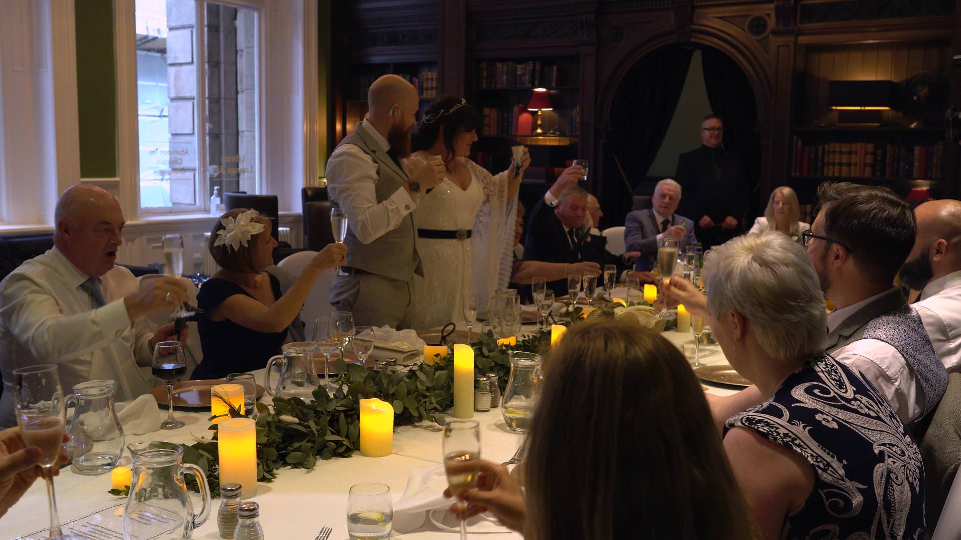 bride and groom raise a toast during reception
