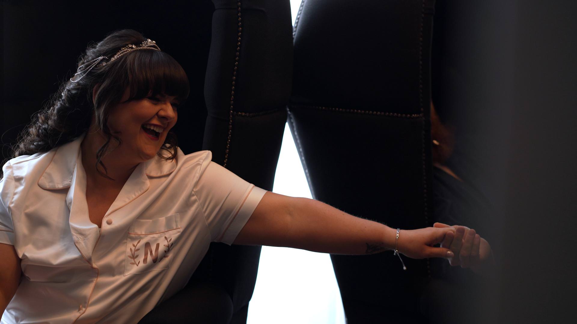 bride reaches out for groom during secret gift giving