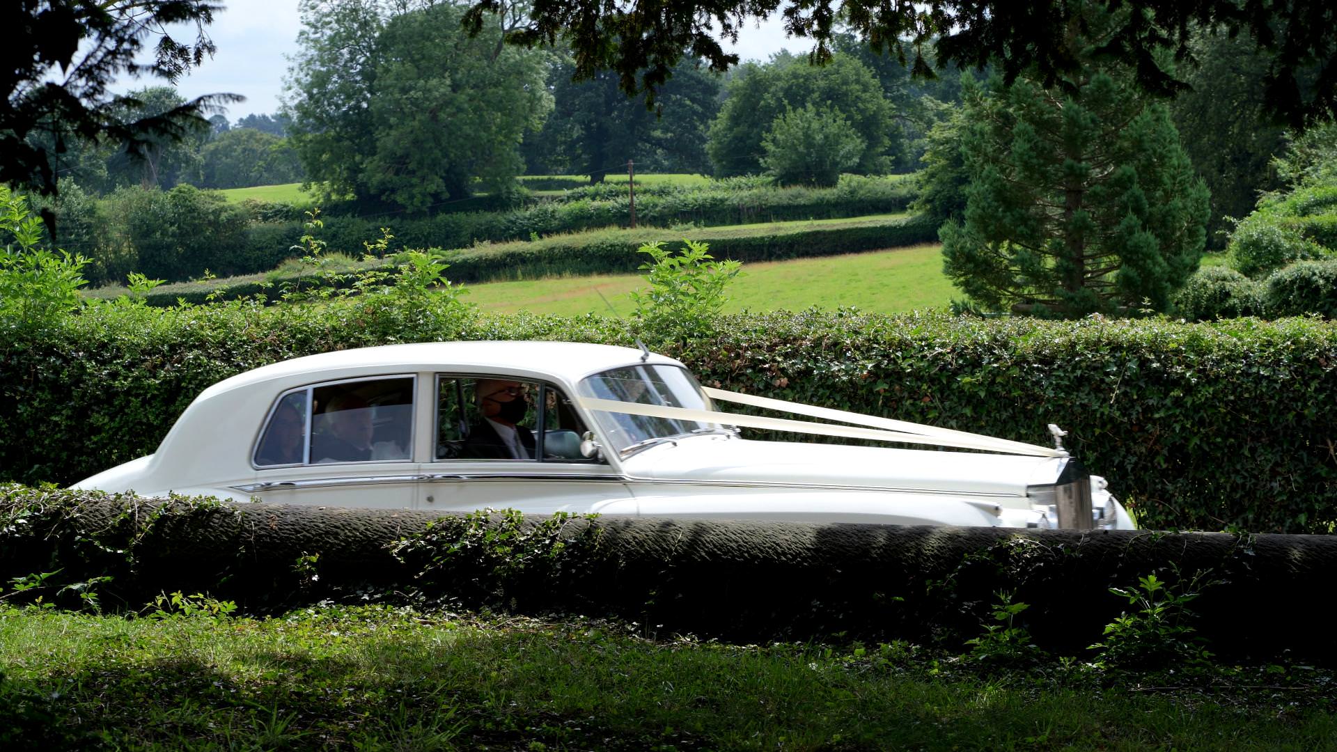 wedding car pulls up to Osmaston Church
