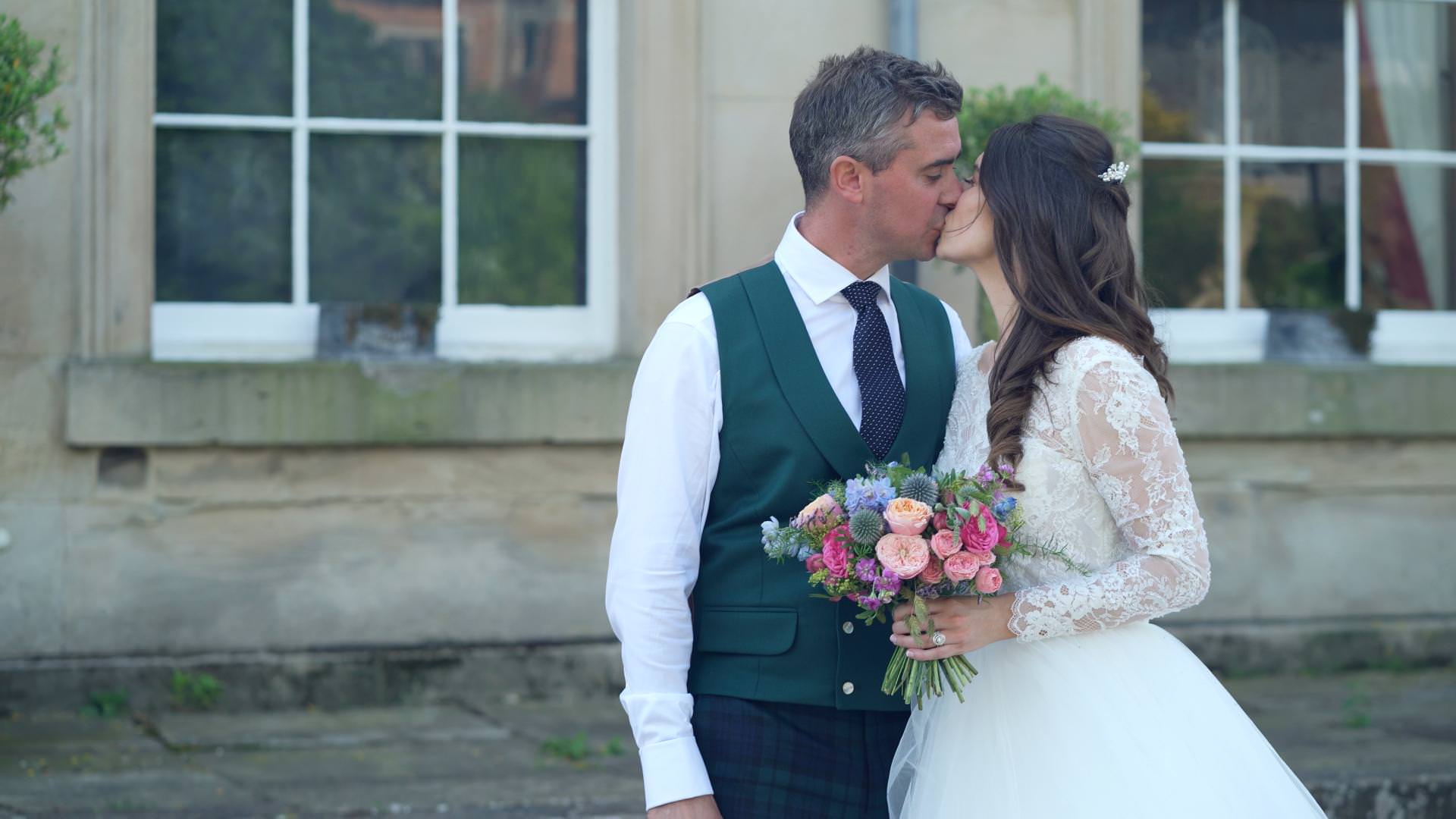 couple kiss outside Barton Hall in Barton Blount