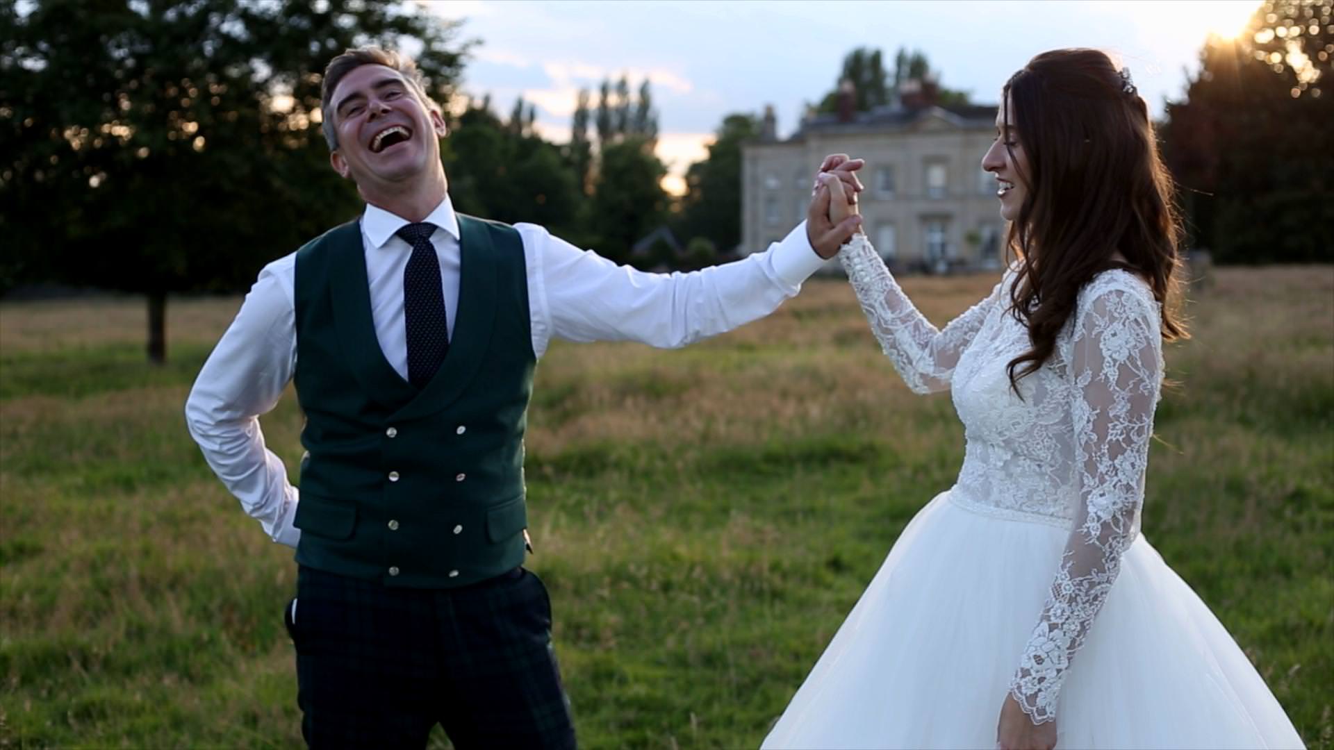 groom laughs with bride outside Barton Hall Estate