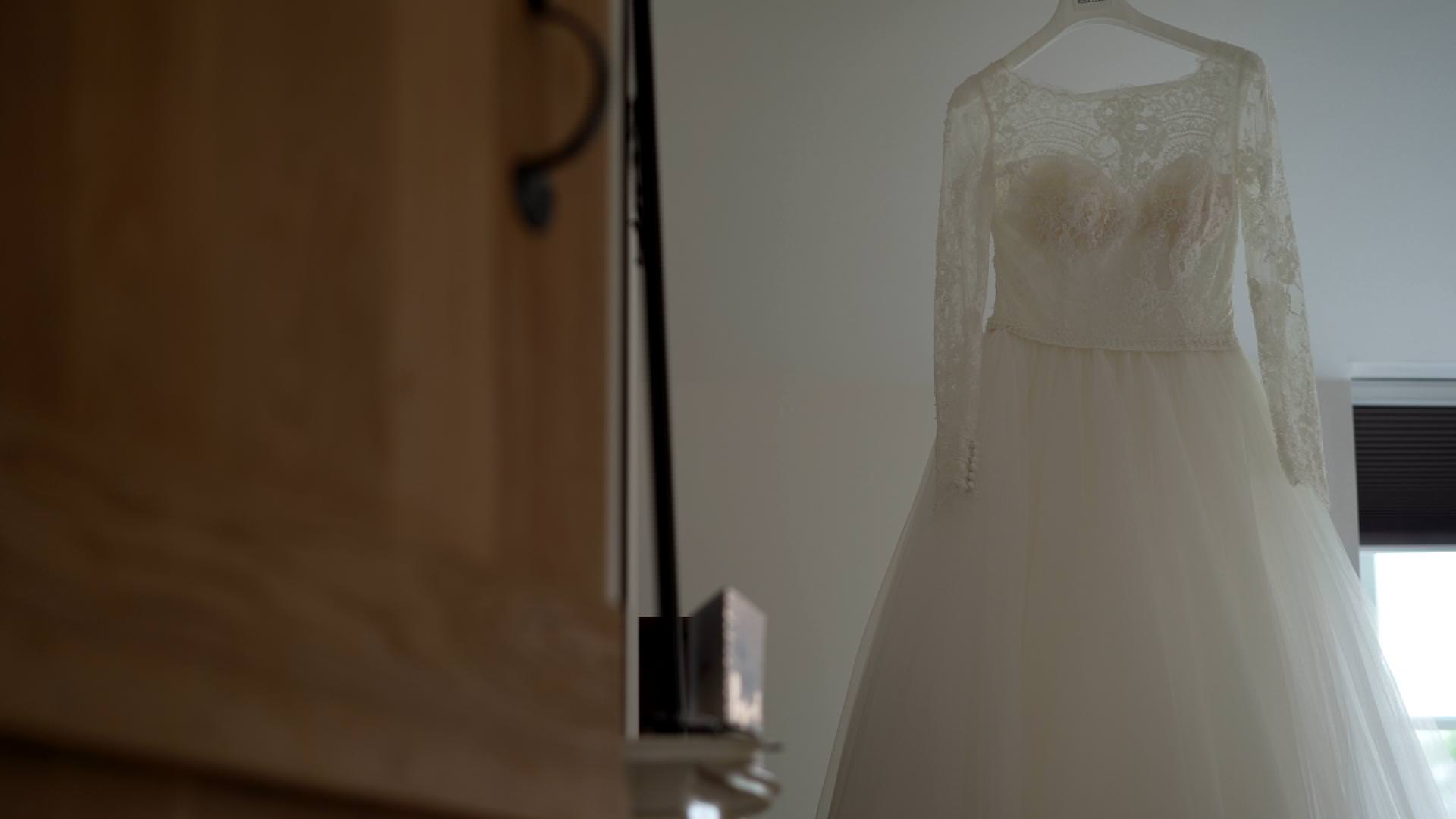 brides lace and tulle dress hangs ready