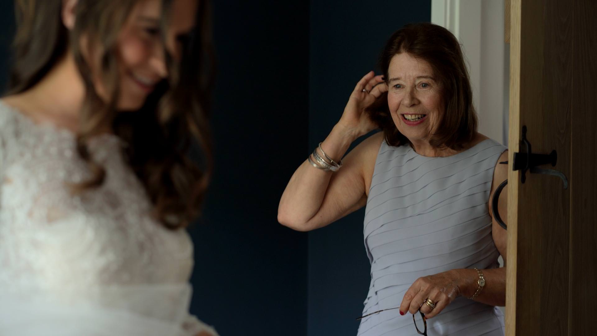 videographer captures mum looking lovingly at bride
