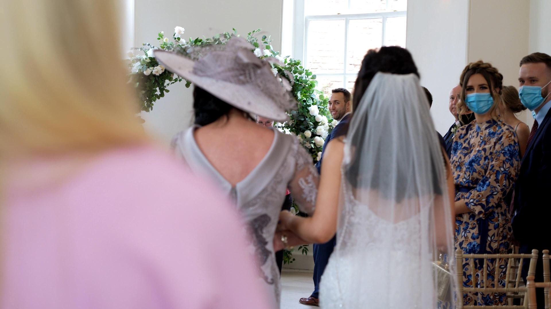 bride walks down aisle at Iscoyd Park