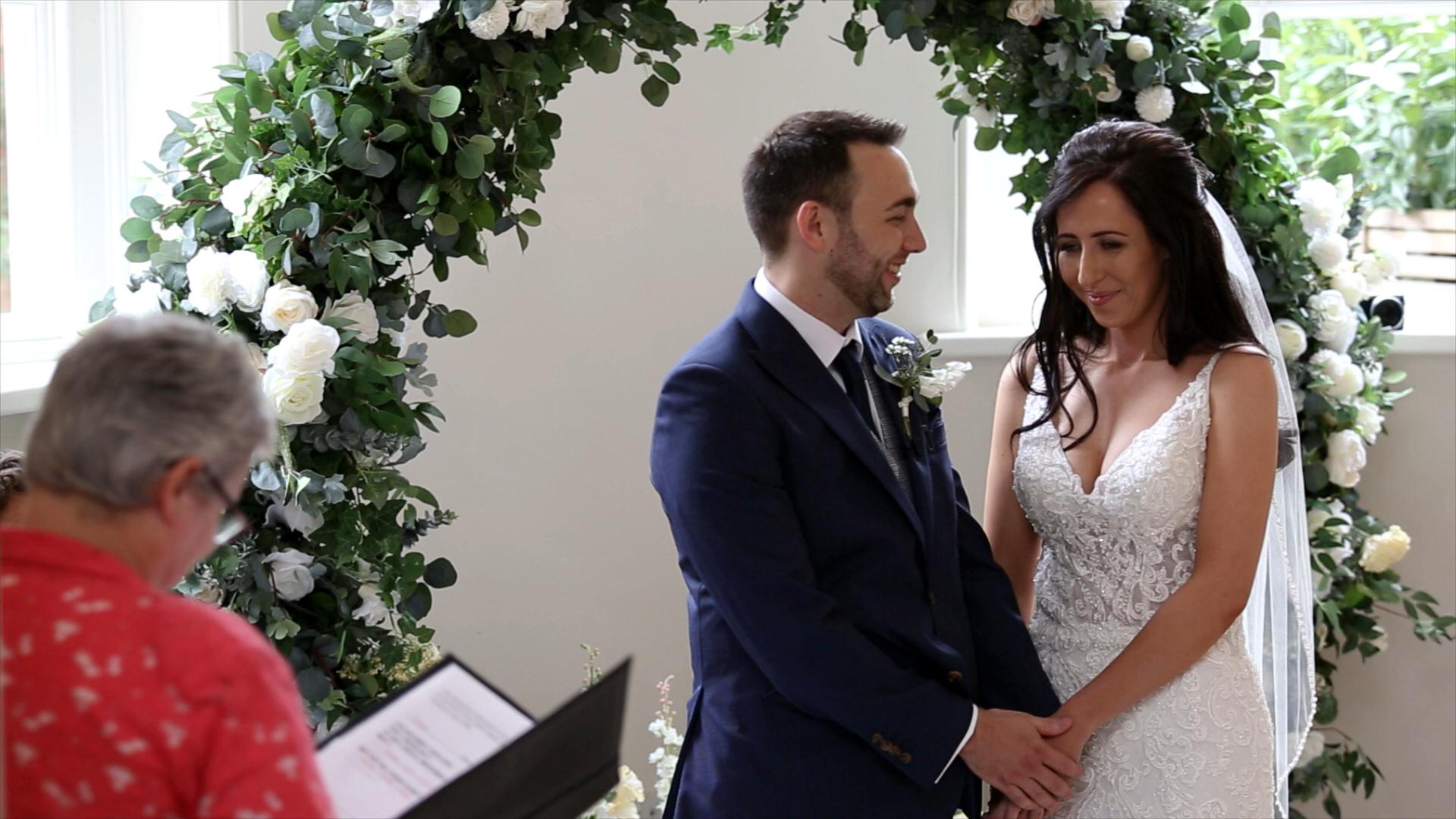 bride and groom hold hands during ceremony in Garden Room Iscoyd Park