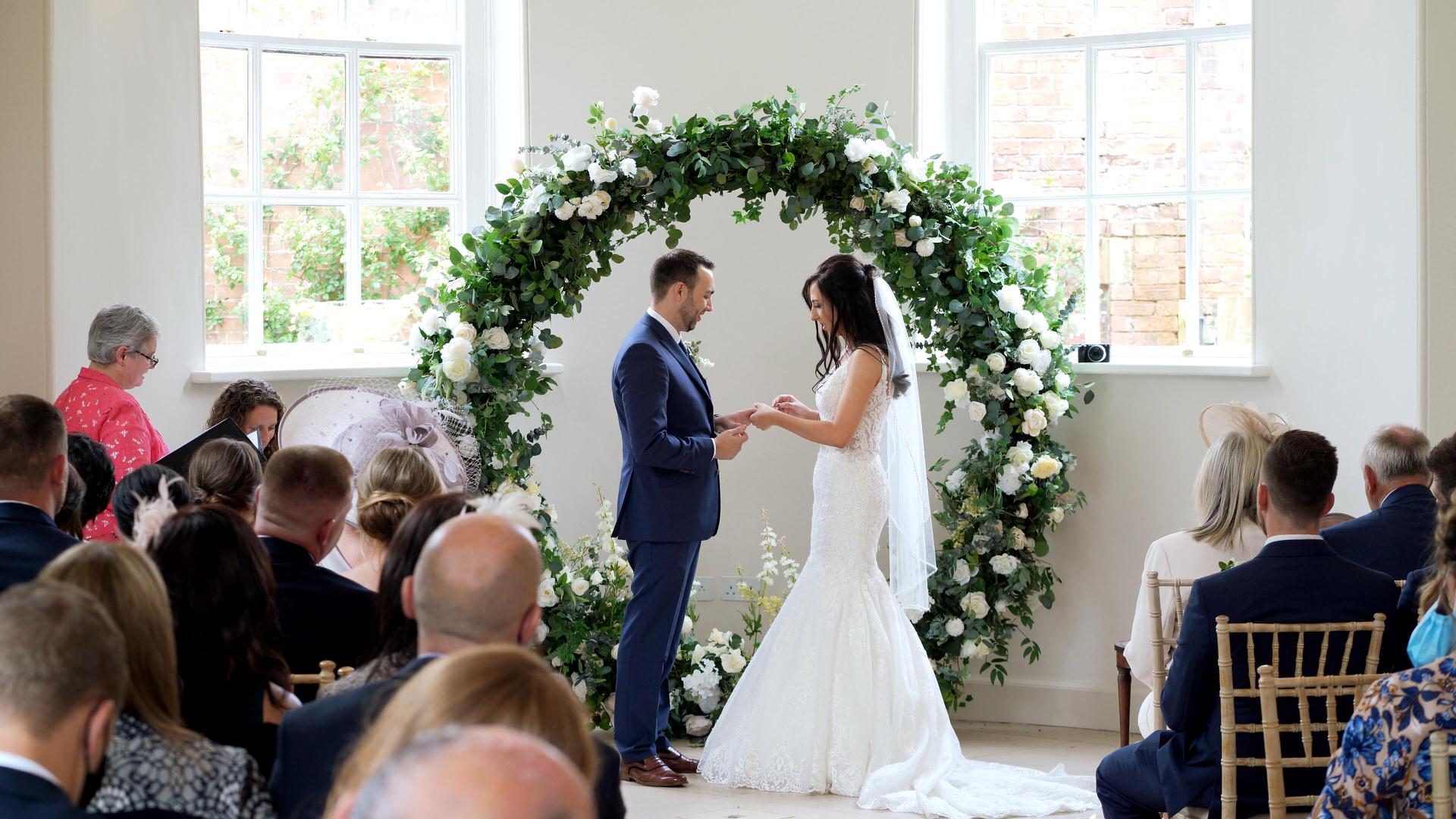 video still of couple exchanging rings during ceremony at Iscoyd