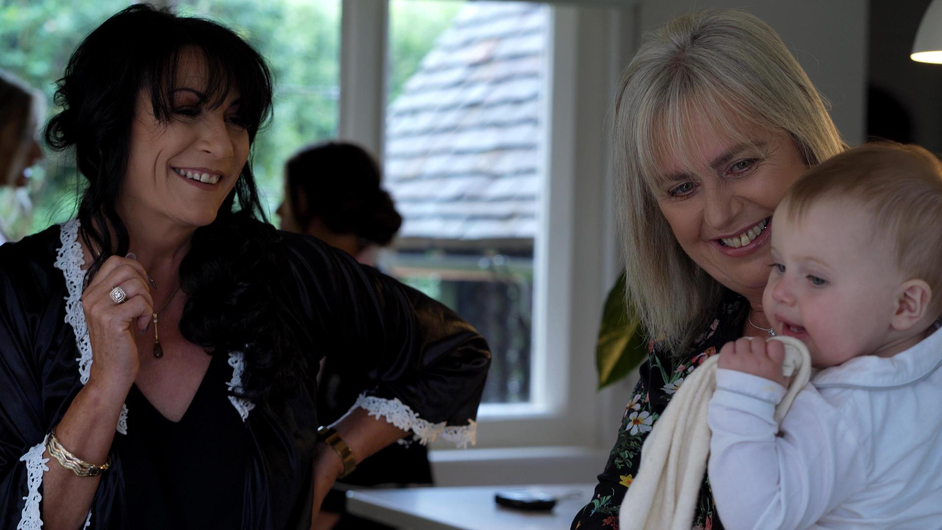 grandparents smiling at flowergirl at wedding