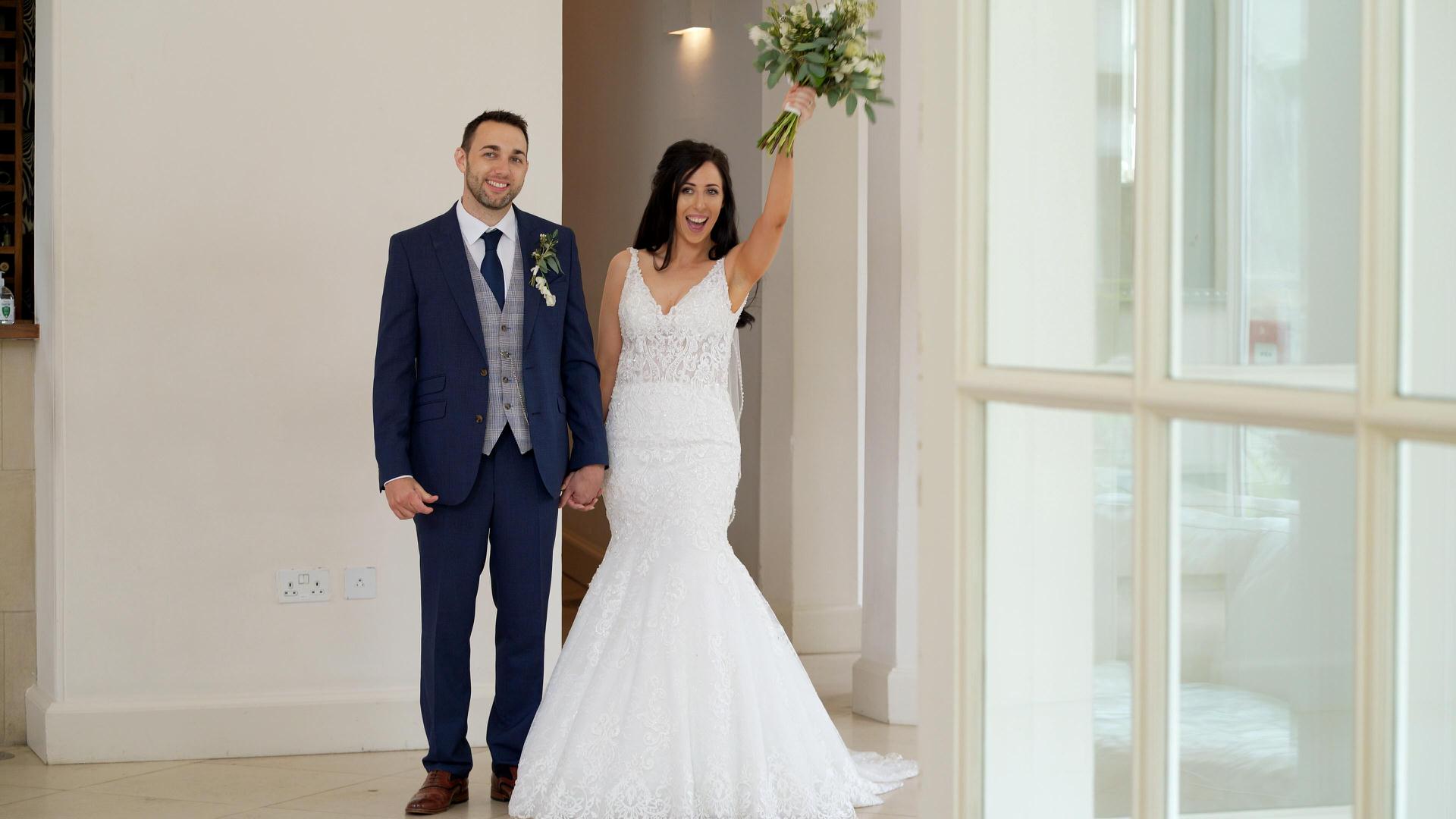 bride cheers before walking in to reception room