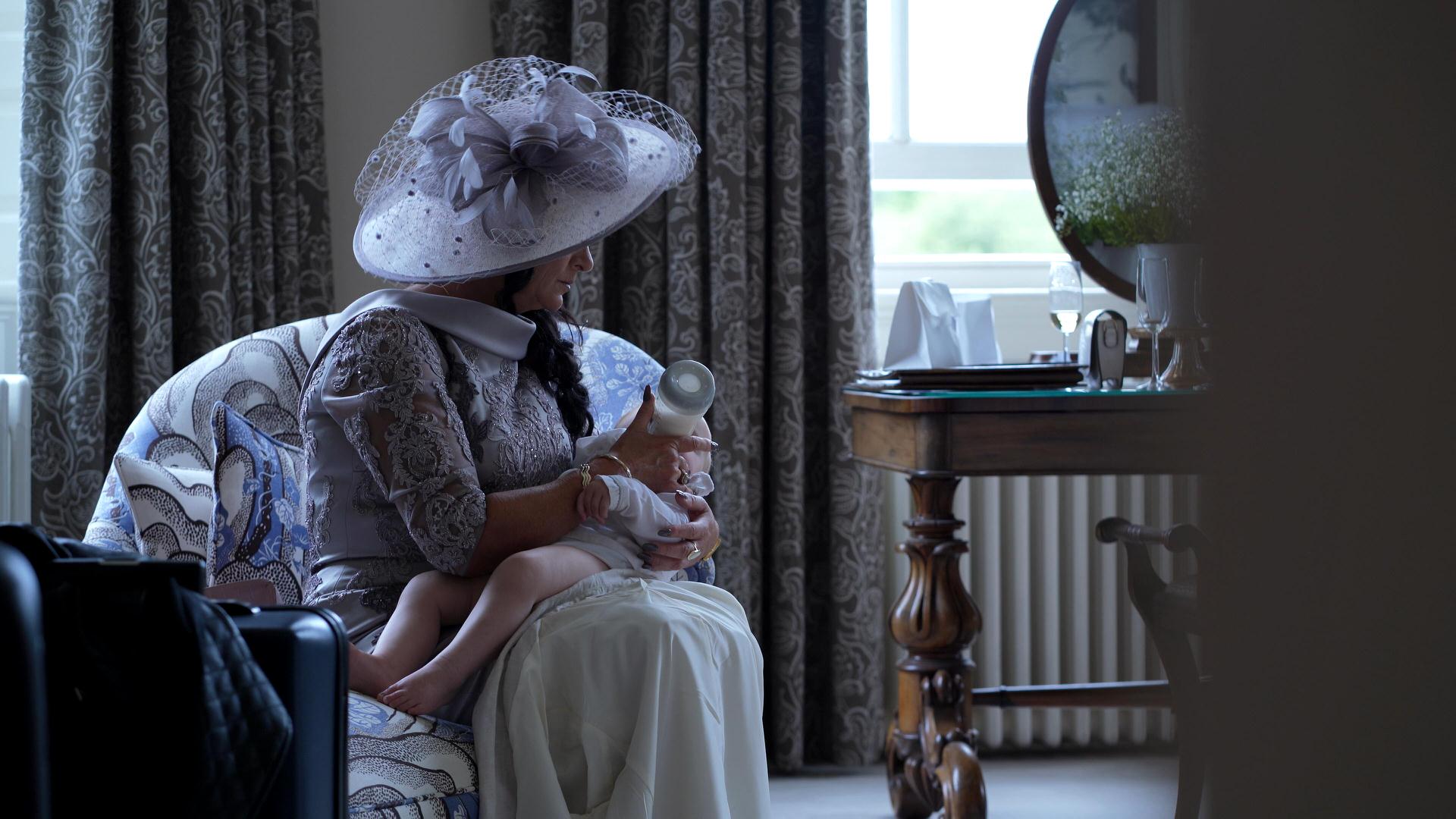 mother of the bride feeds a baby at Iscoyd