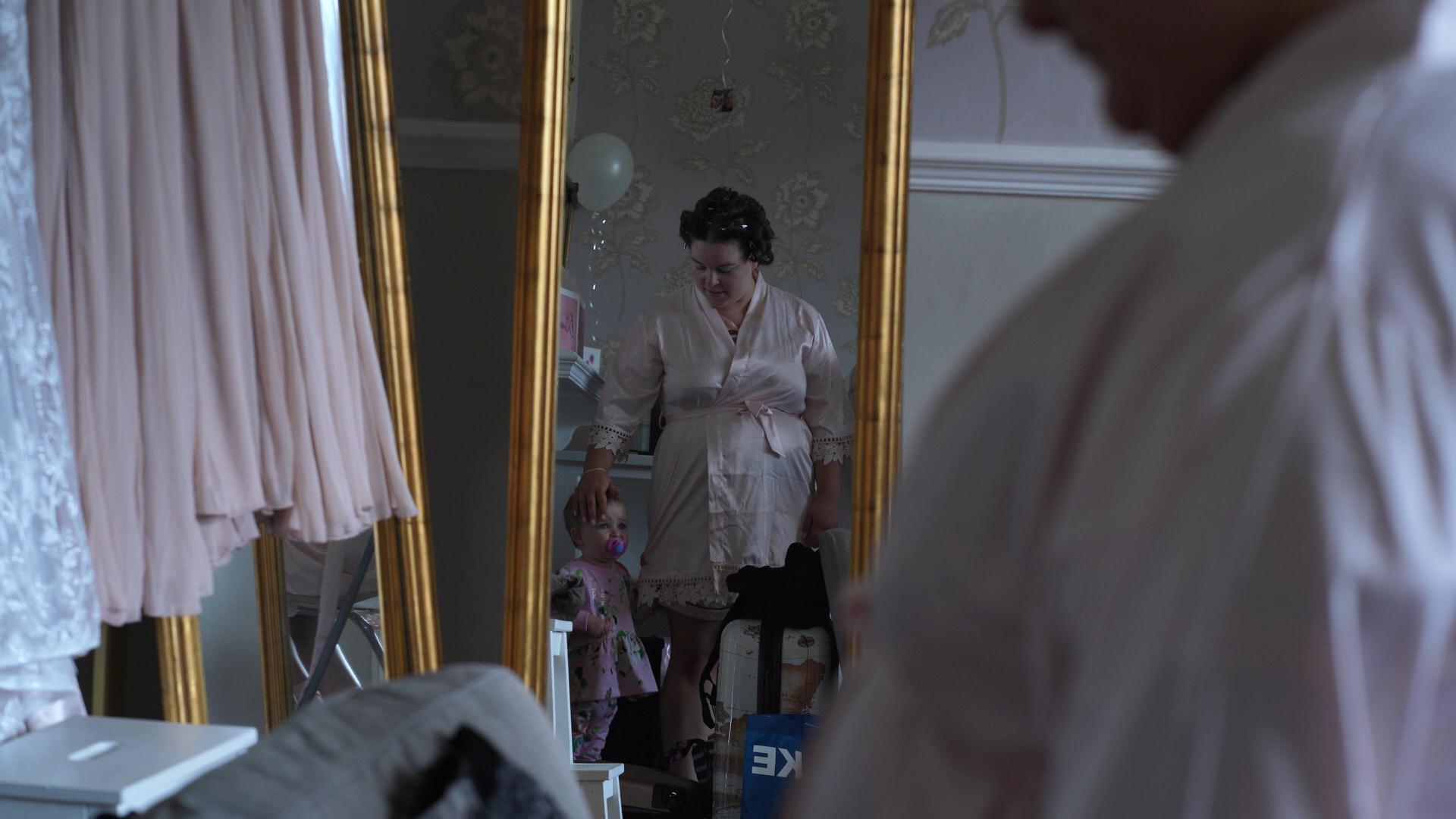 bridesmaid and flower girl video still in mirror