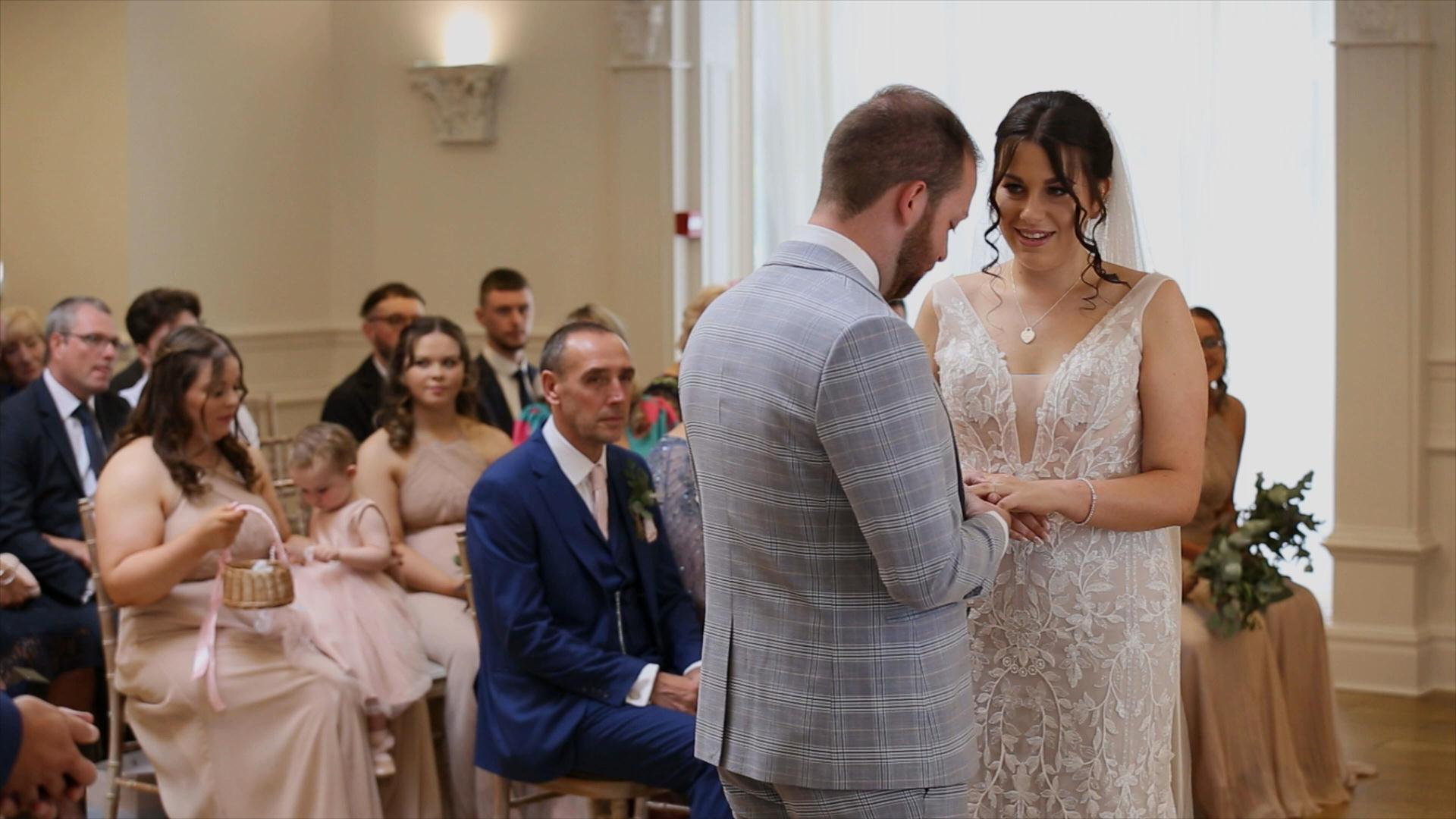 couple exchange wedding rings during ceremony at Ashfield House