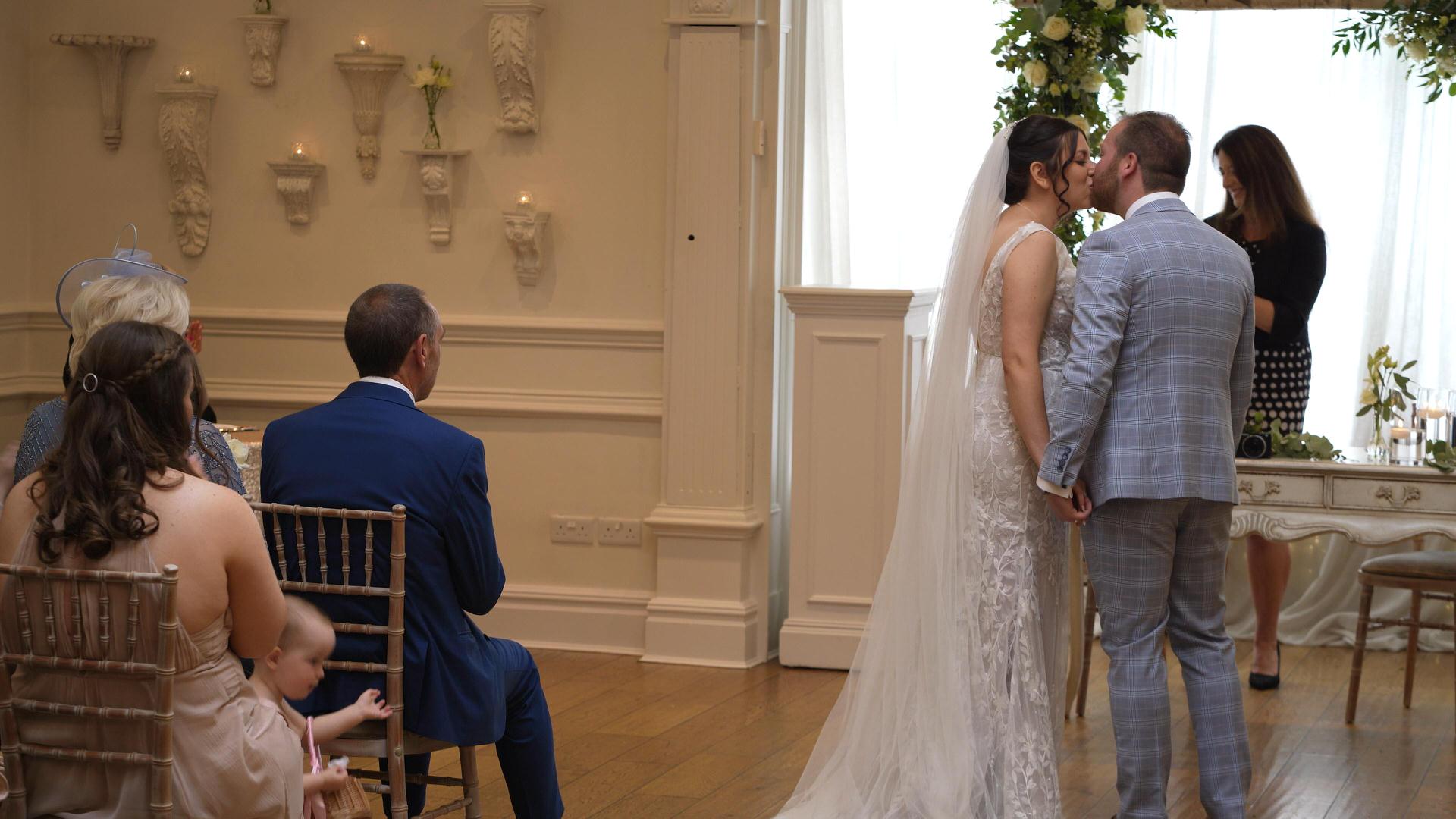 couple kiss during ceremony at ashfield house