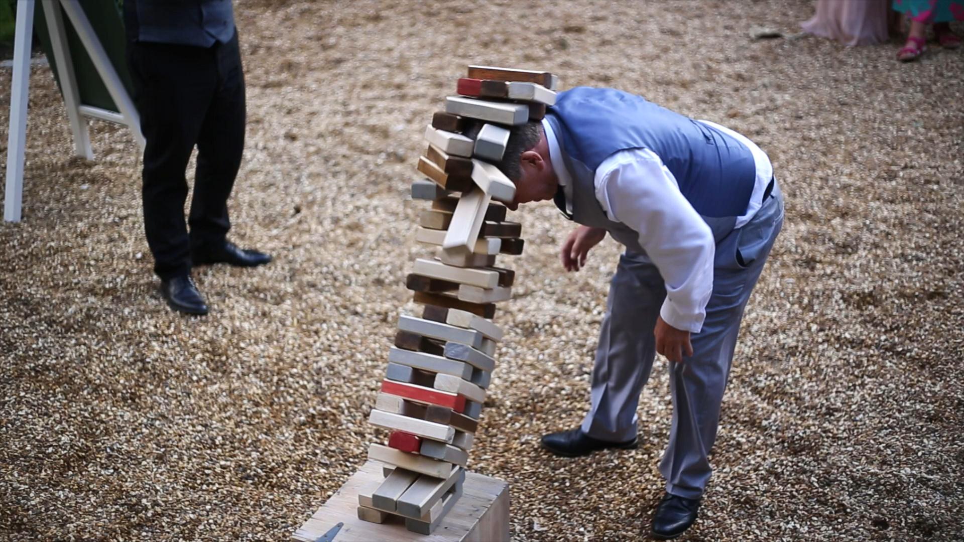 giant jenga falls and hits wedding guest on head