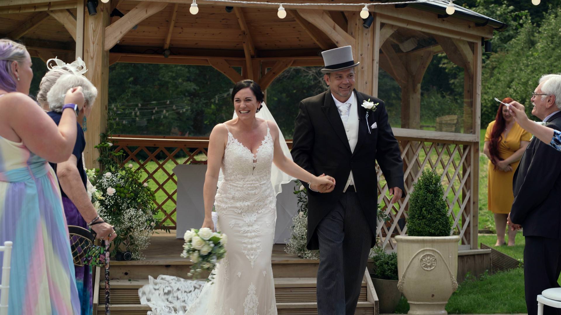 couple walk down the aisle during wedding