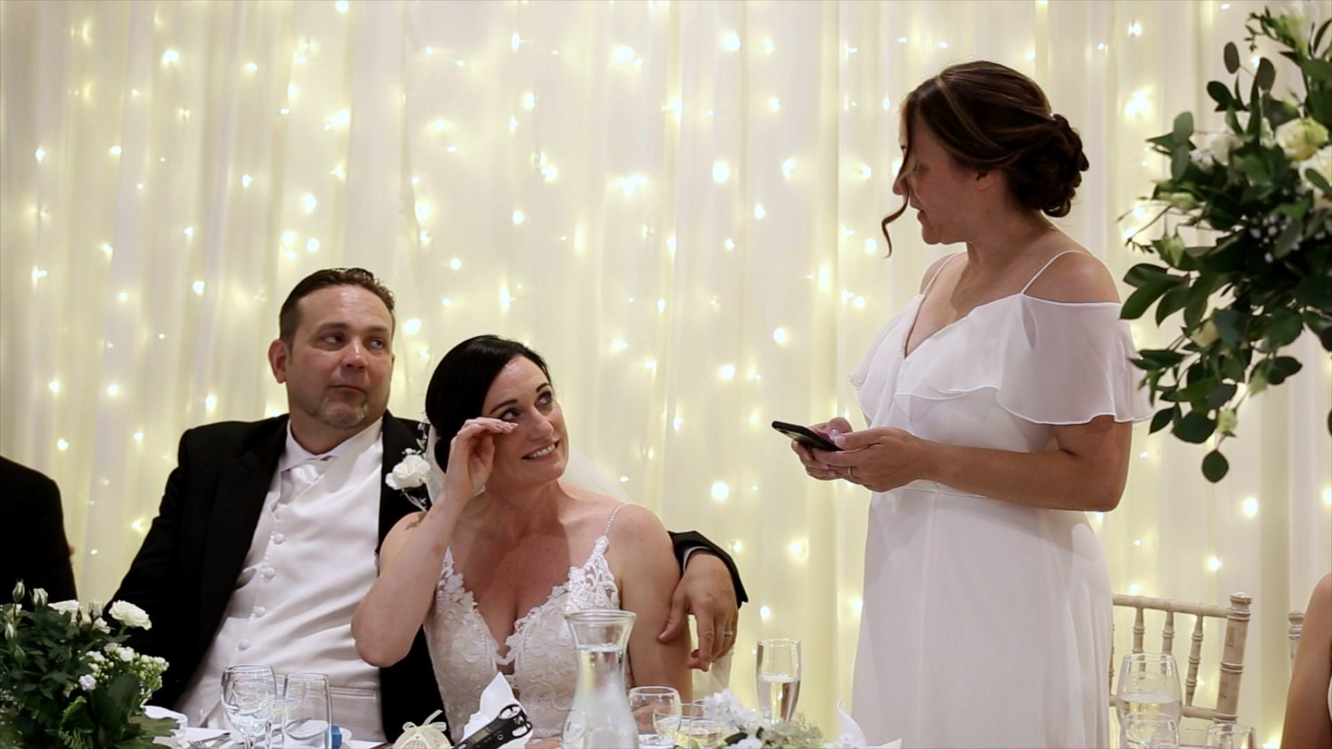bride wipes tears as best friend gives wedding speech