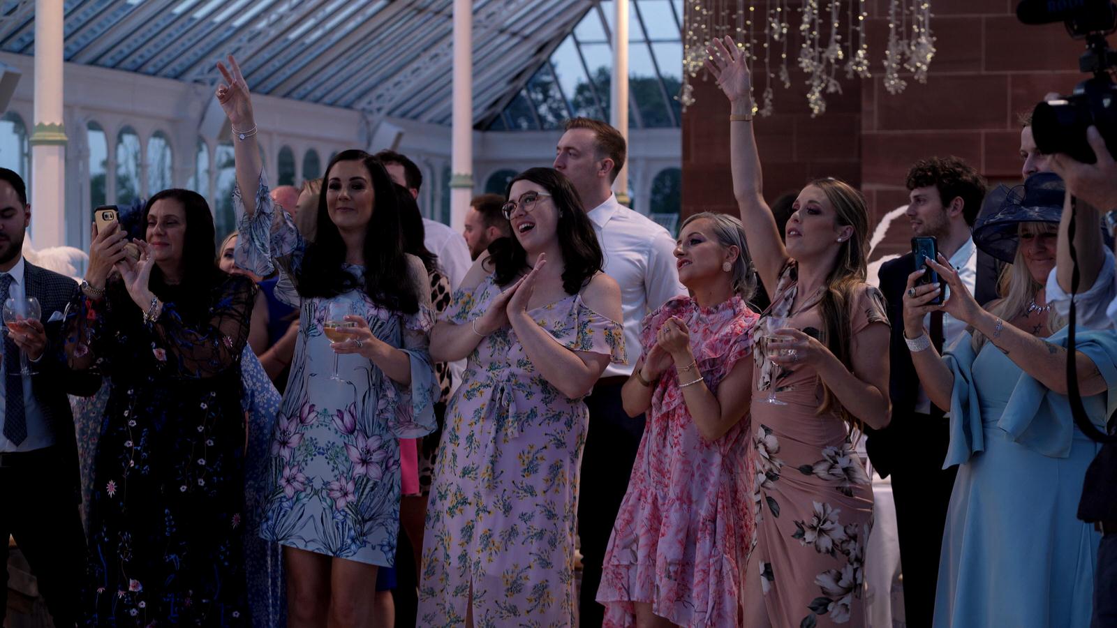guests sing along during first dance