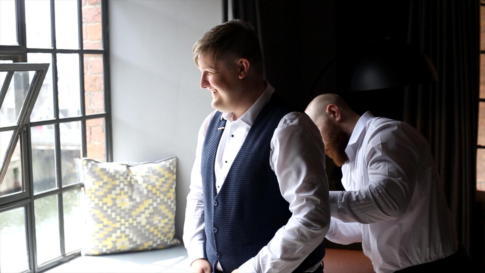 groom looks out of a window at Titanic Hotel