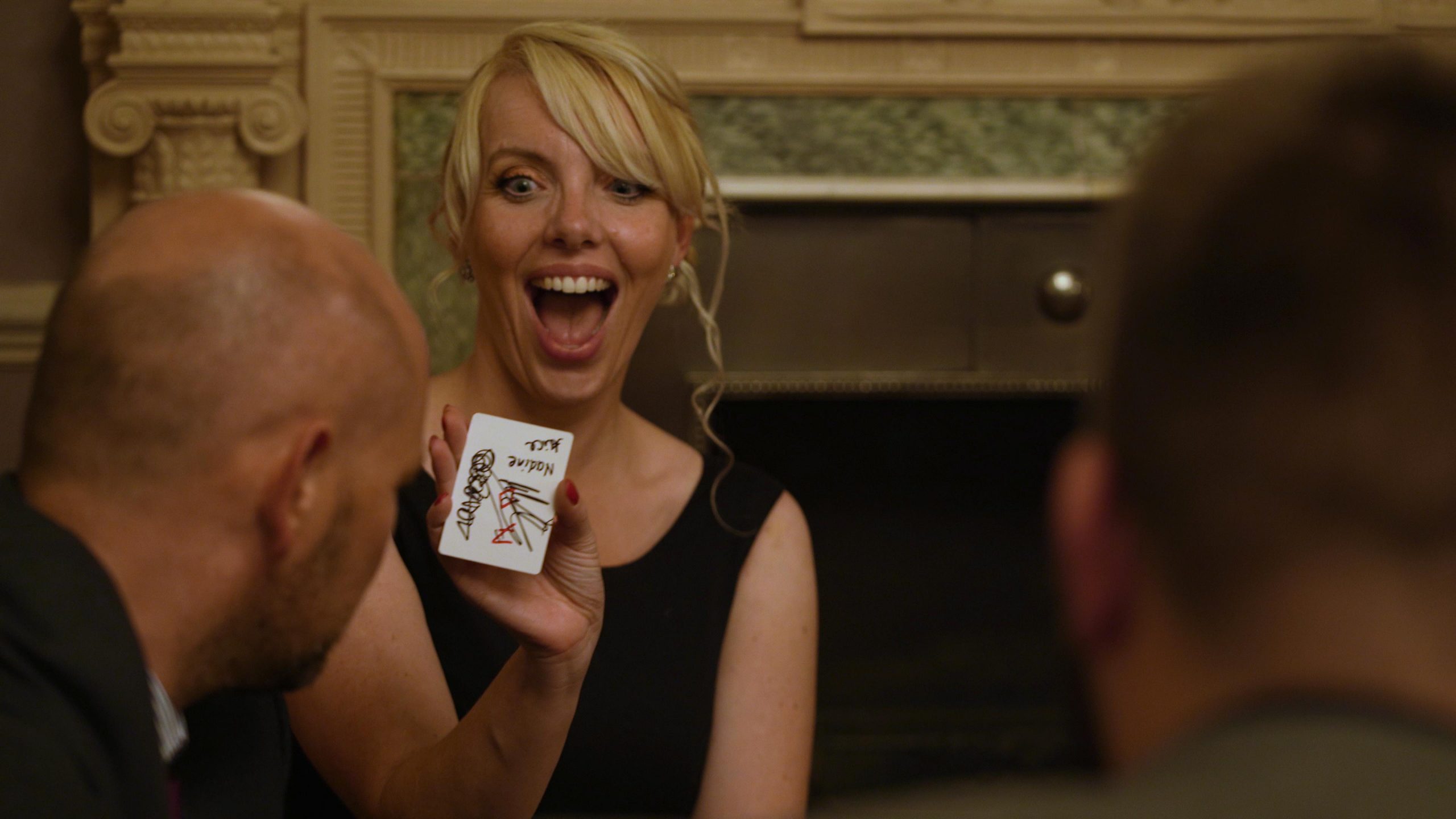 guest looks shocked by magicians card trick at wedding