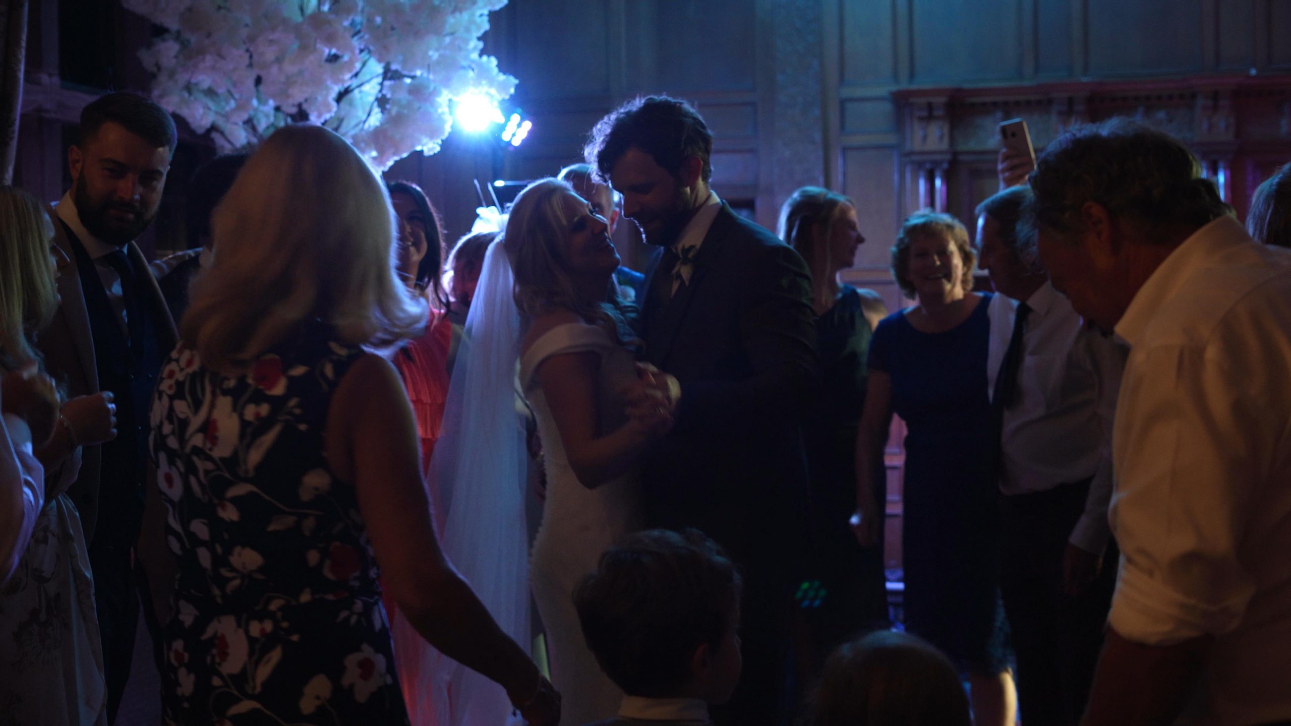 guests crowd around the couple on the dancefloor