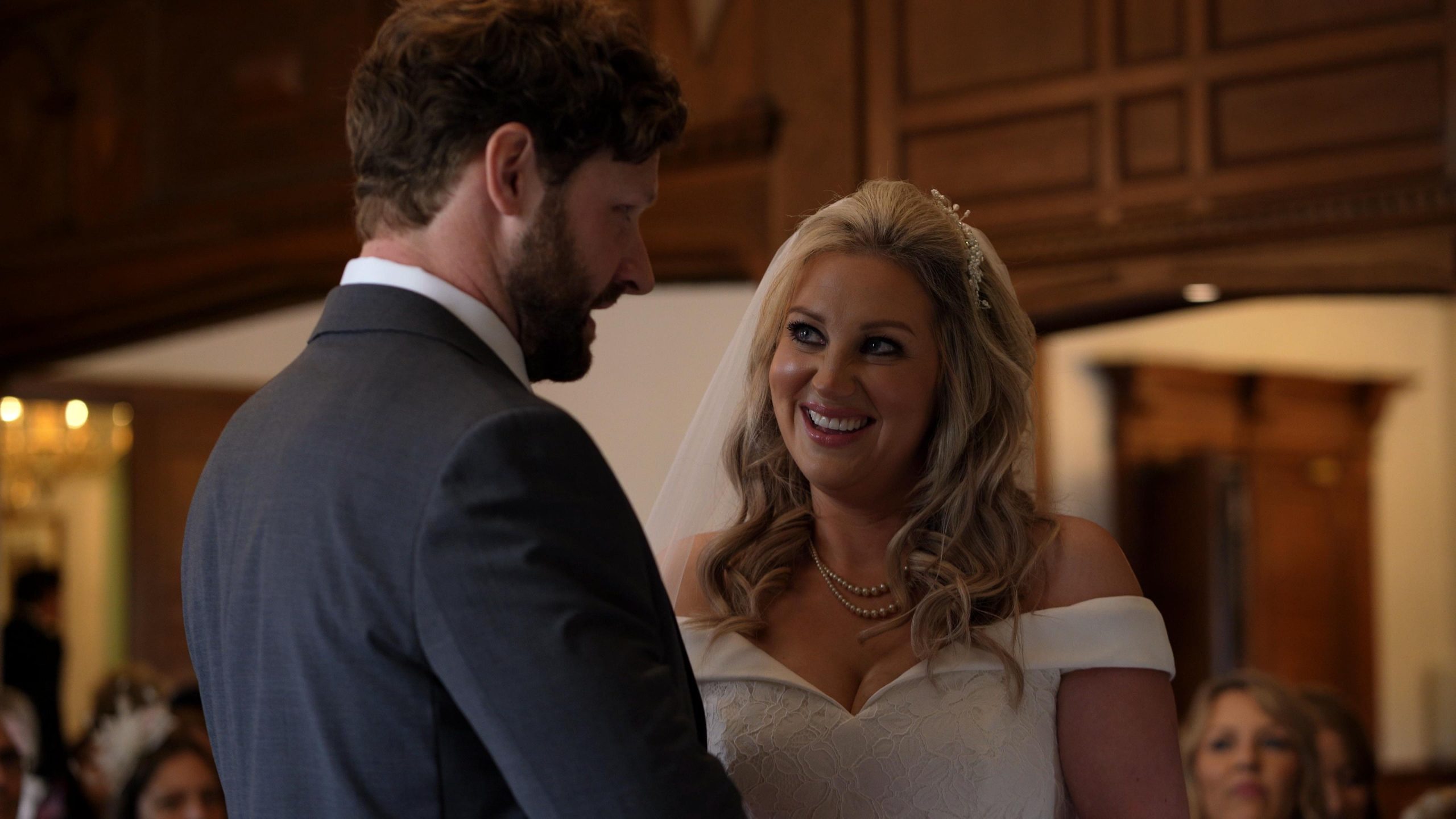 bride smiles at groom during wedding ceremony