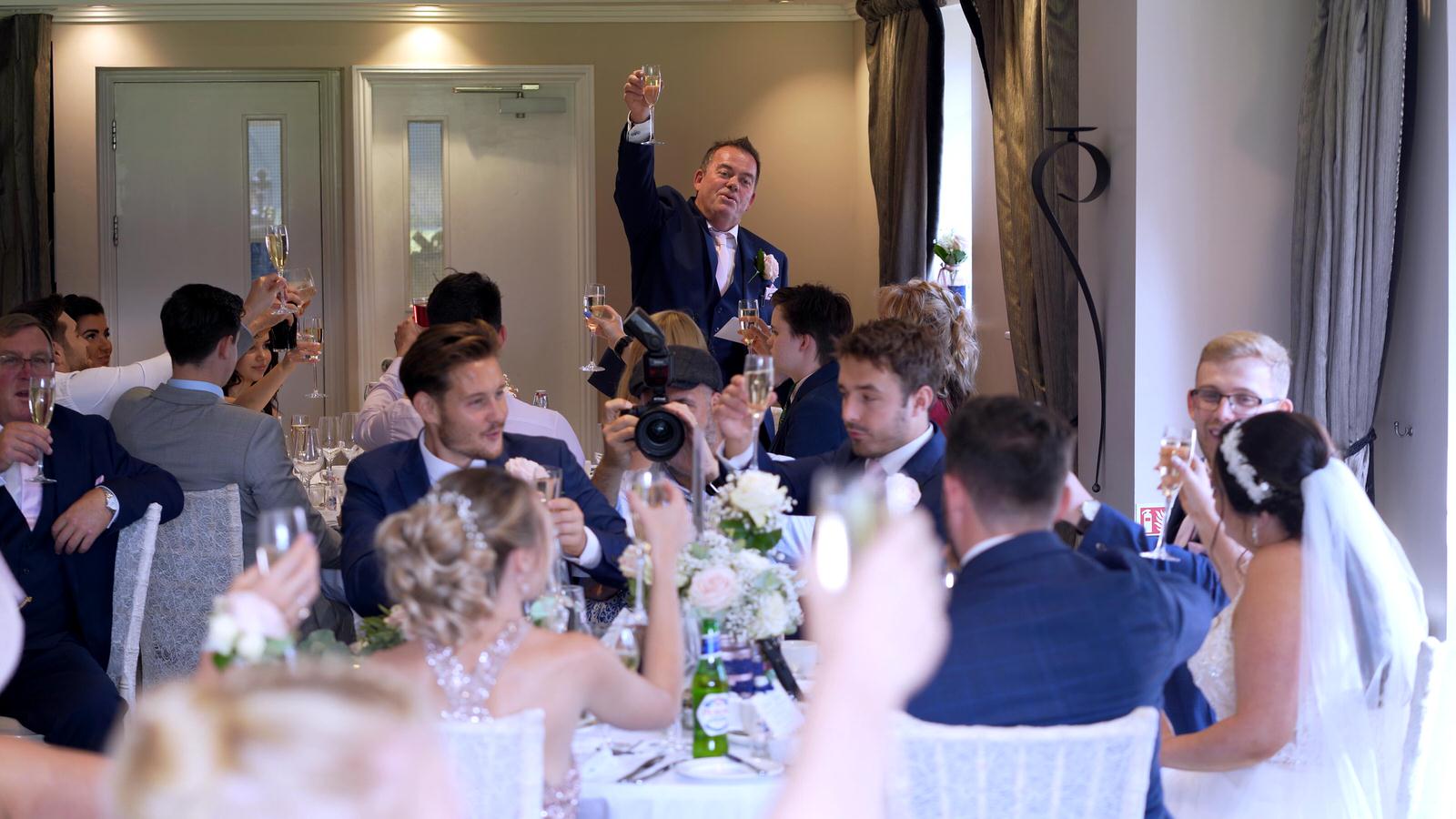 father of the bride raises a toast during speeches