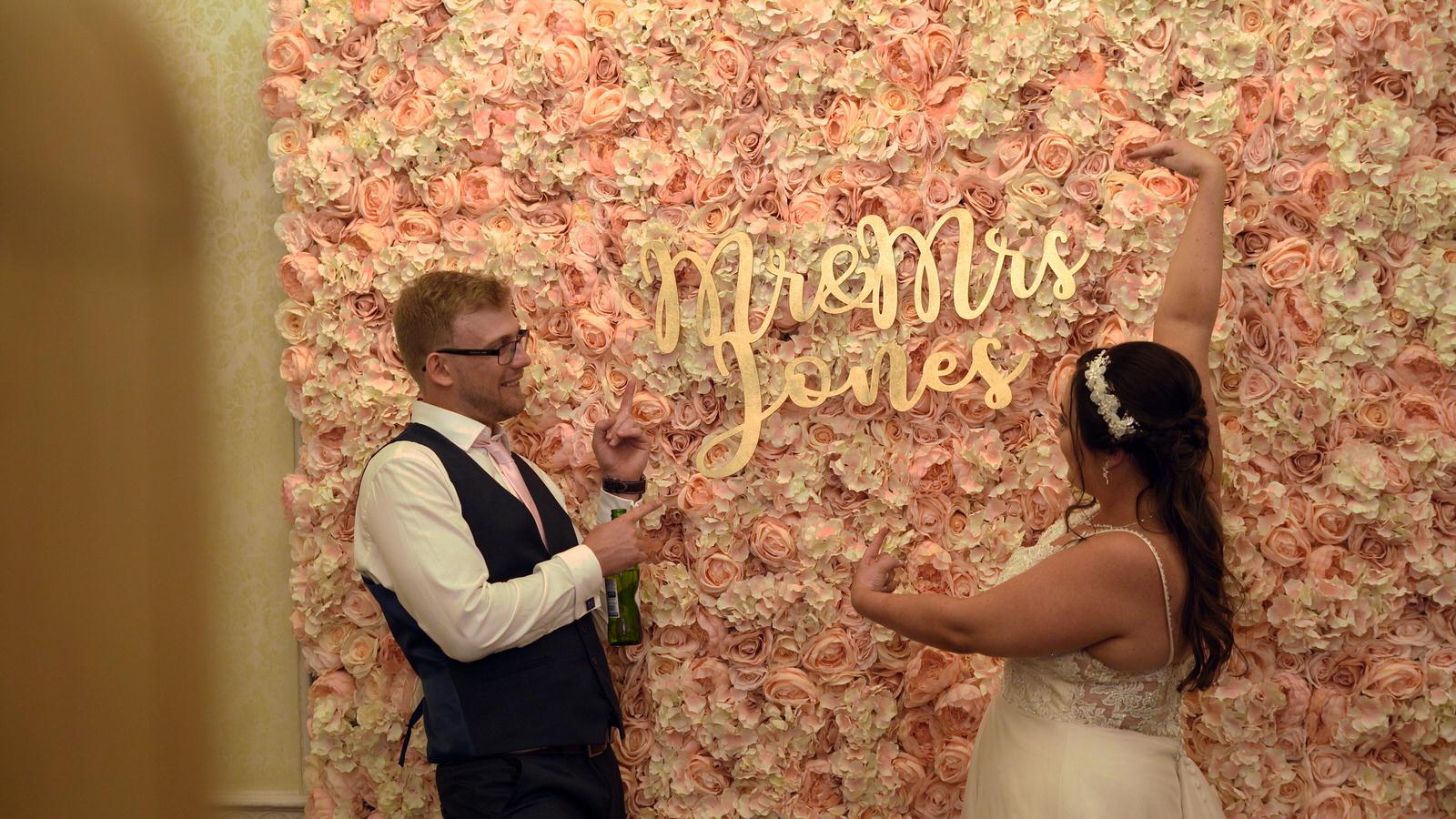 couple pose and point for Lovely Booths photo booth