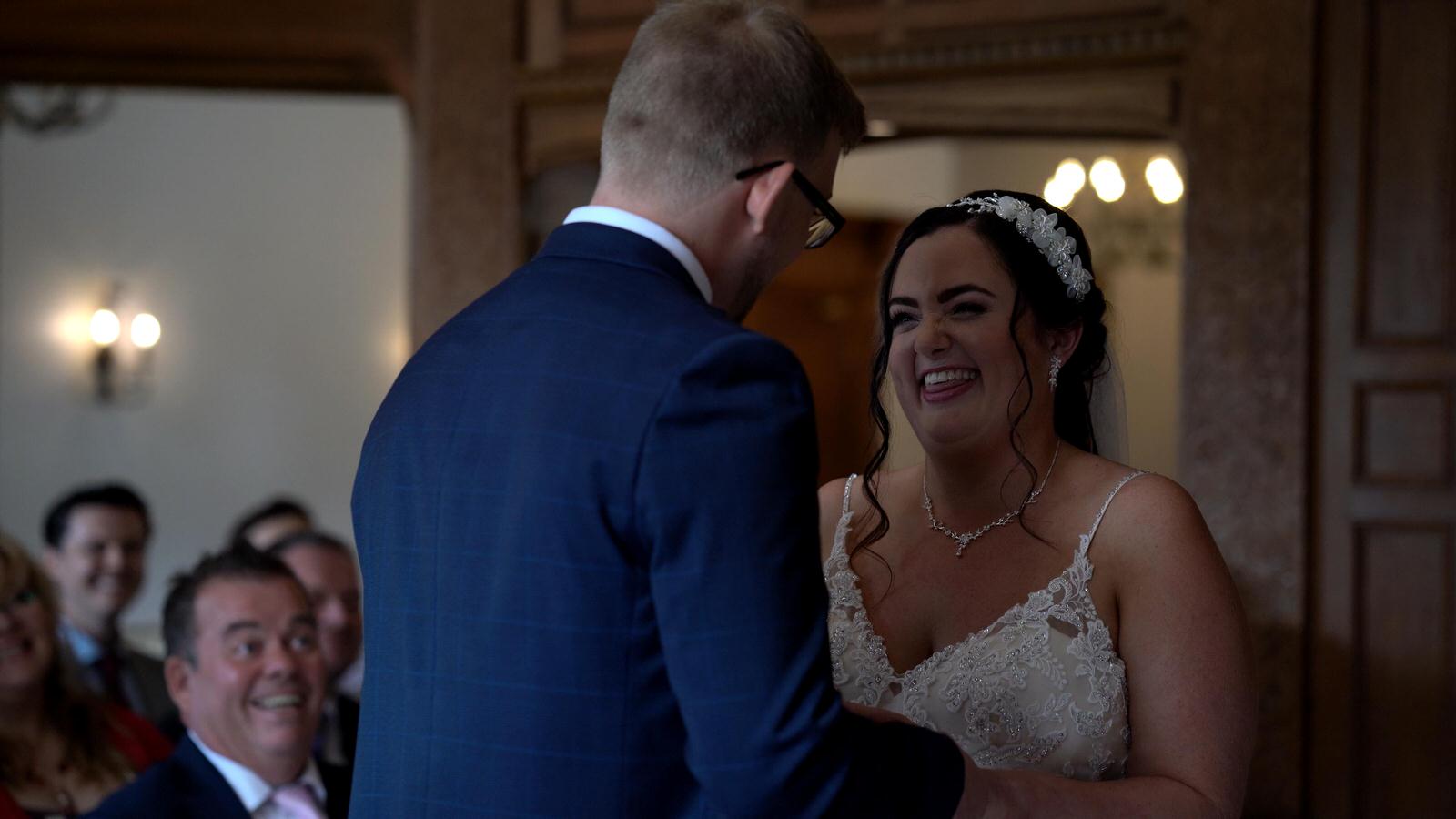 bride and groom laugh with each other during ceremony