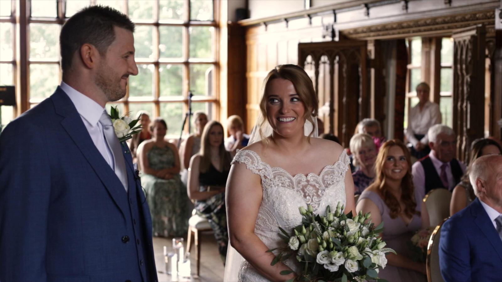 bride smiles at groom during wedding ceremony at Hillbark hotel