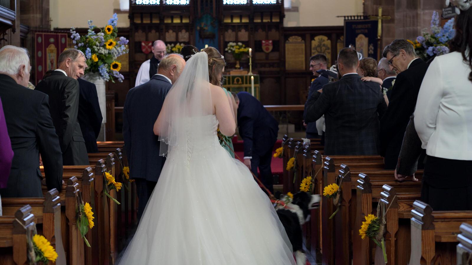 bride and da walk down aisle with dog ring barer