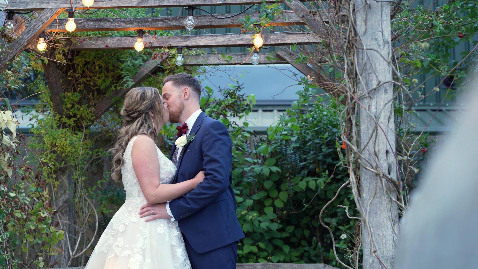 couple kiss outside owen house barn