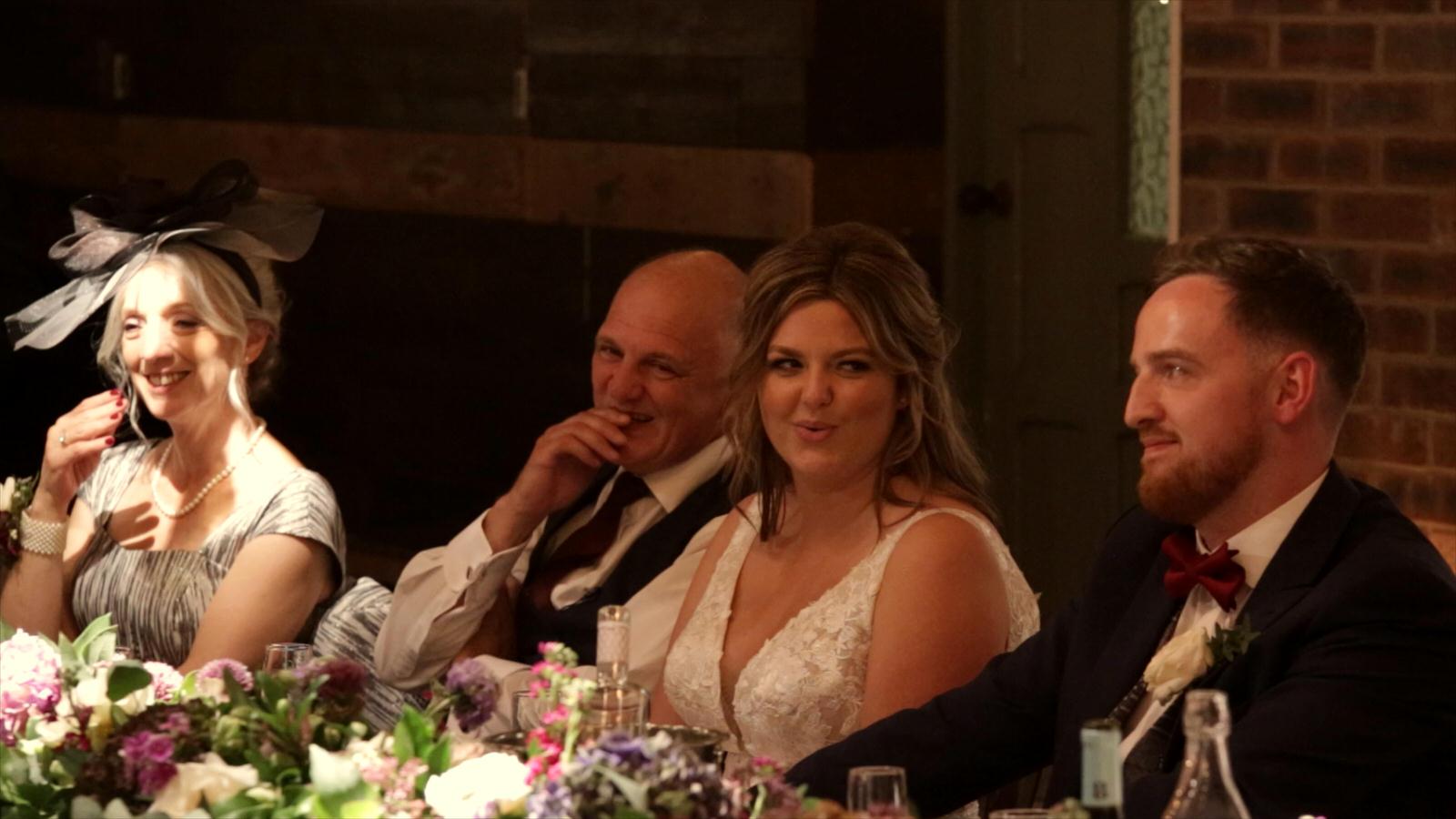 video still of couple during wedding speeches