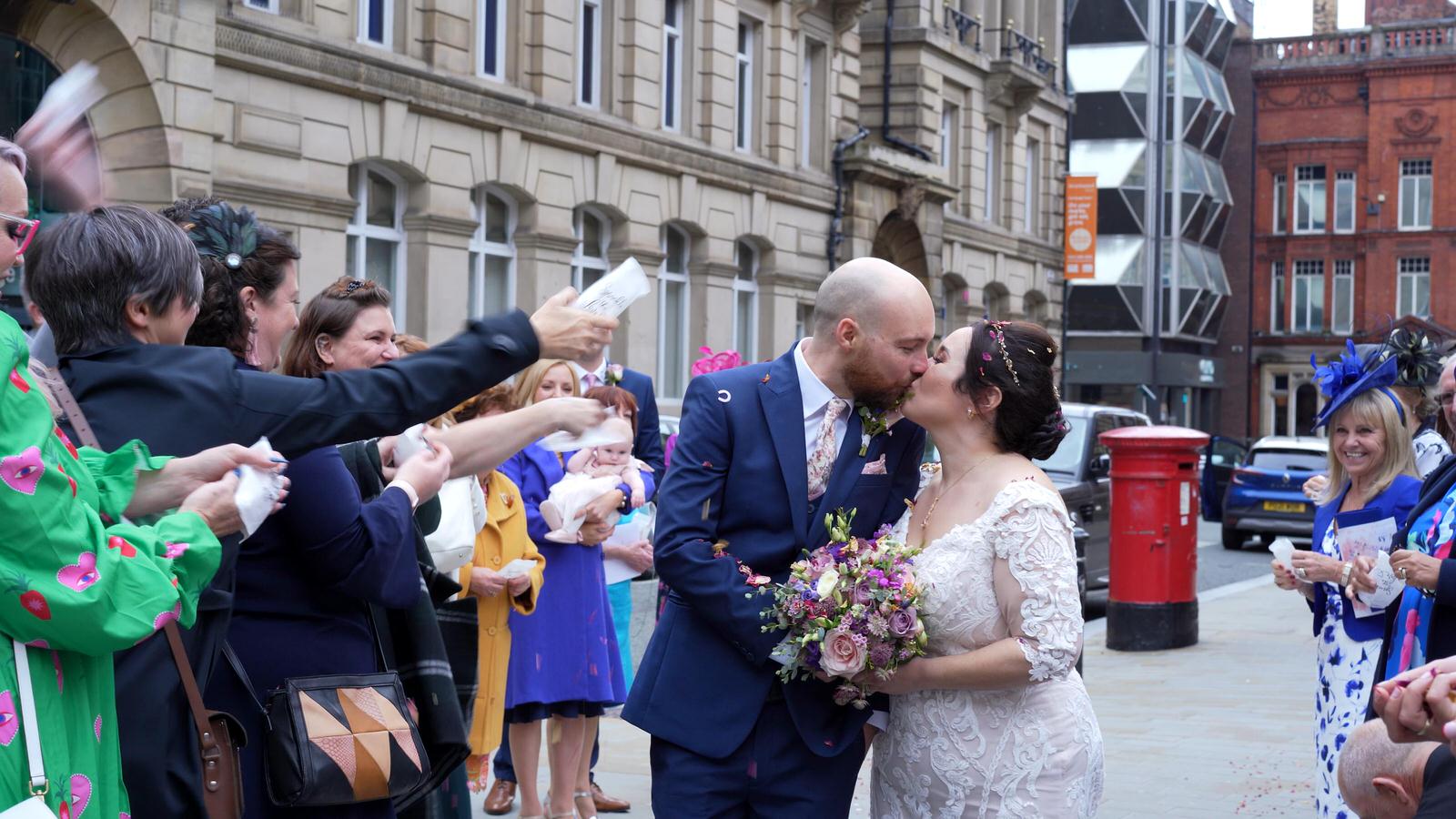 couple kiss during confetti in liverpool